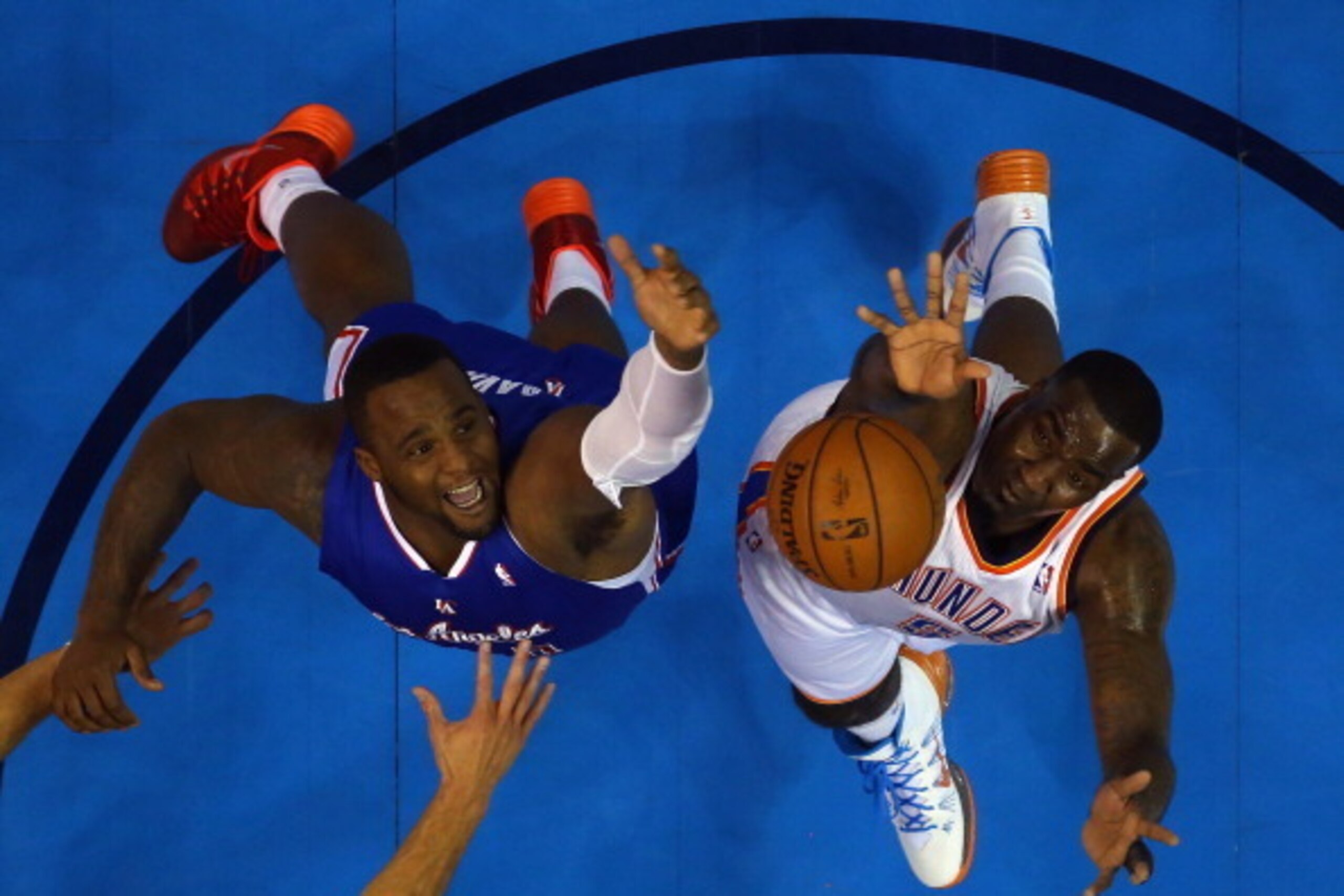 OKLAHOMA CITY, OK - MAY 13:  Glen Davis #0 of the Los Angeles Clippers jumps for a rebound against Kendrick Perkins #5 of the Oklahoma City Thunder in Game Five of the Western Conference Semifinals during the 2014 NBA Playoffs at Chesapeake Energy Arena o