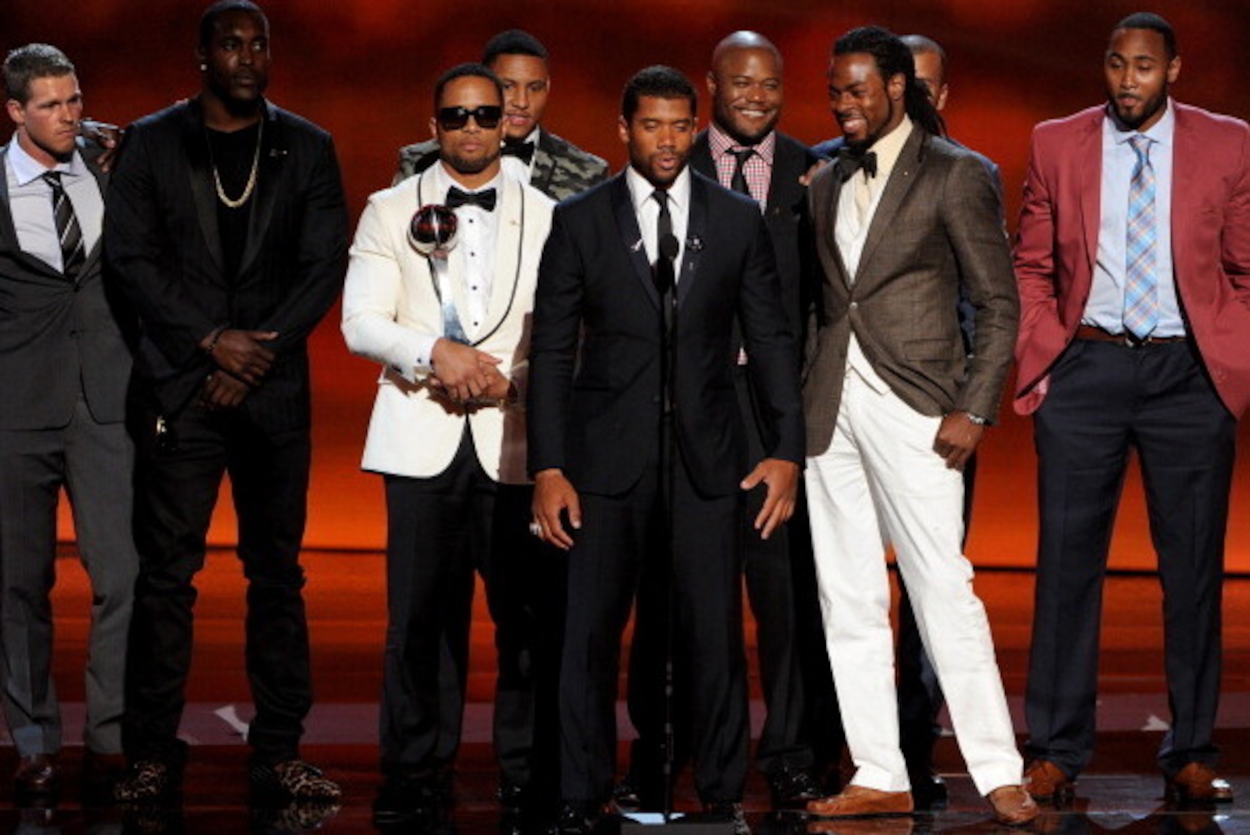 LOS ANGELES, CA - JULY 16:  (L-R) NFL players Golden Tate, Malcolm Smith, Russell Wilson, Richard Sherman and teammates from the Seattle Seahawks accept the Best Team award onstage during the 2014 ESPYS at Nokia Theatre L.A. Live on July 16, 2014 in Los A