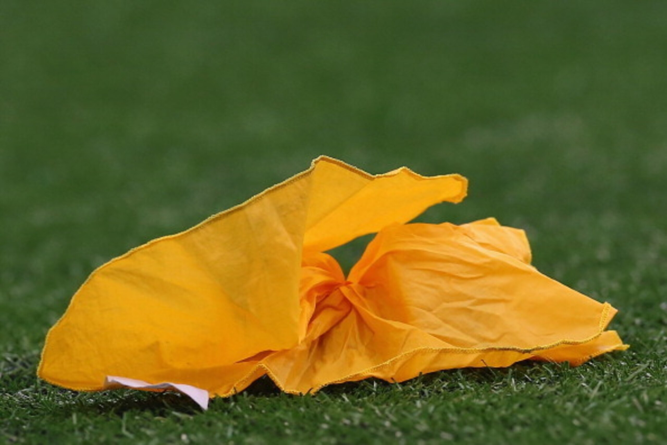ARLINGTON, TX - SEPTEMBER 22:  A yellow penalty flag on the field during play between the St. Louis Rams and the Dallas Cowboys at AT&T Stadium on September 22, 2013 in Arlington, Texas.  (Photo by Ronald Martinez/Getty Images)