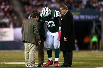EAST RUTHERFORD, NJ - OCTOBER 08:  Kenrick Ellis #93 of the New York Jets is tended to after he was injured against the Houston Texans at MetLife Stadium on October 8, 2012 in East Rutherford, New Jersey. The Texans won 23-17.  (Photo by Elsa/Getty Images