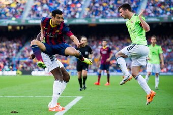 BARCELONA, SPAIN - MARCH 16: Pedro Rodriguez (L) of FC Barcelona and Oier Sanjurjo of CA Osasuna (R) in action during the La Liga match between FC Barcelona and CA Osasuna at Camp Nou on March 16, 2014 in Barcelona, Spain. (Photo by Alex Caparros/Getty Im