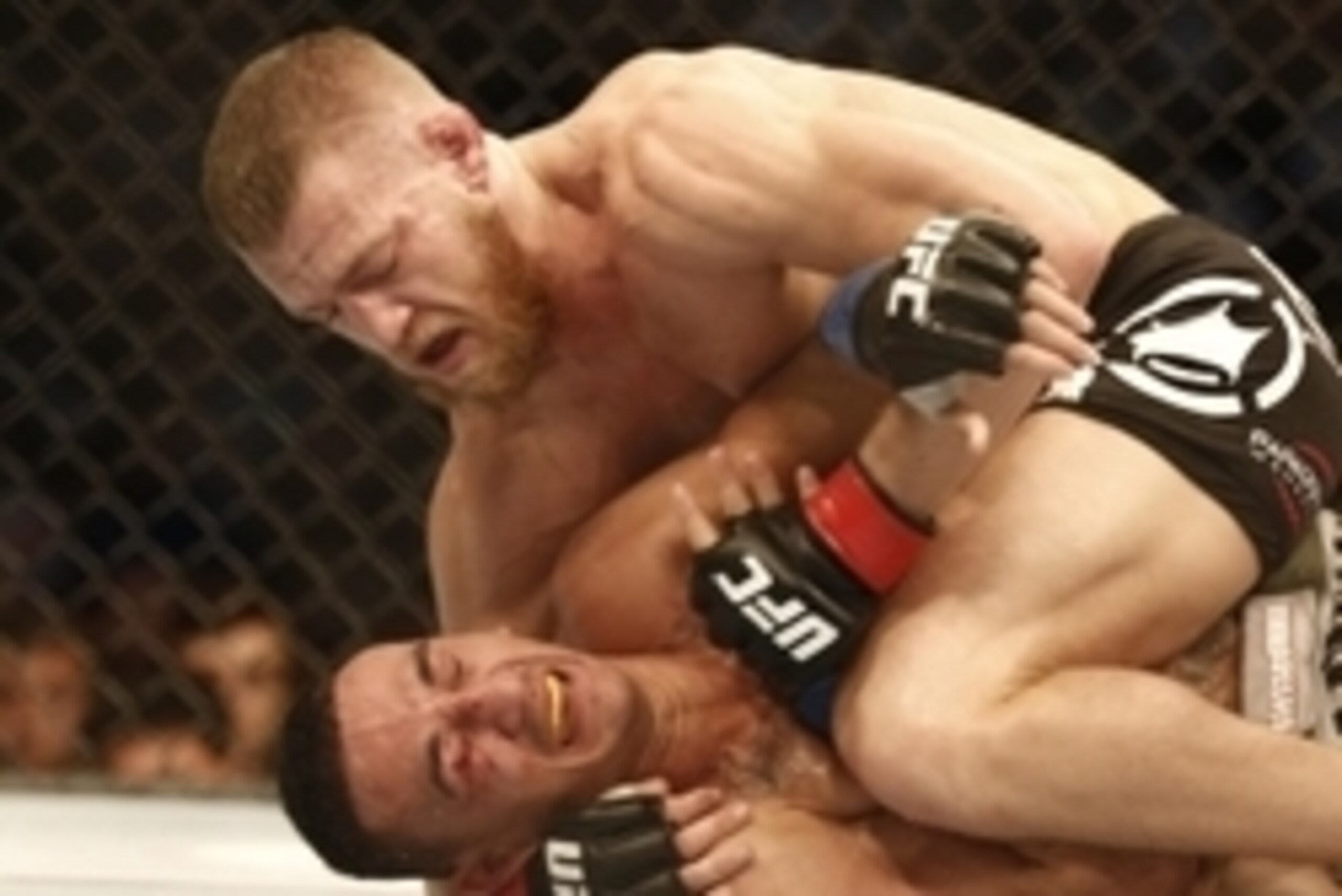 Aug 17, 2013; Boston, MA, USA; Conor McGregor (black shorts) and Max Holloway (white shorts) fight  during a UFC featherweight match at the TD Garden. McGregor won after three rounds by judges decision. Mandatory Credit: Winslow Townson-USA TODAY Sports