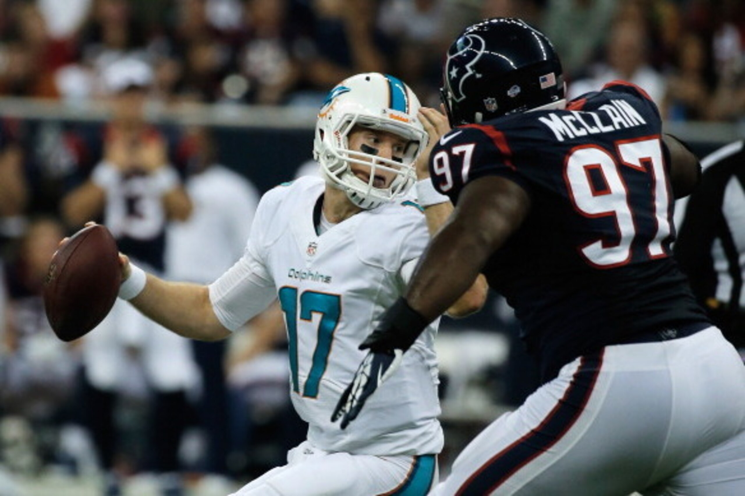 HOUSTON, TX - AUGUST 17:  Ryan Tannehill #17 of the Miami Dolphins is pressured by Terrell McClain #97 of the Houston Texans during a preseaon game at Reliant Stadium on August 17, 2013 in Houston, Texas.  (Photo by Scott Halleran/Getty Images)