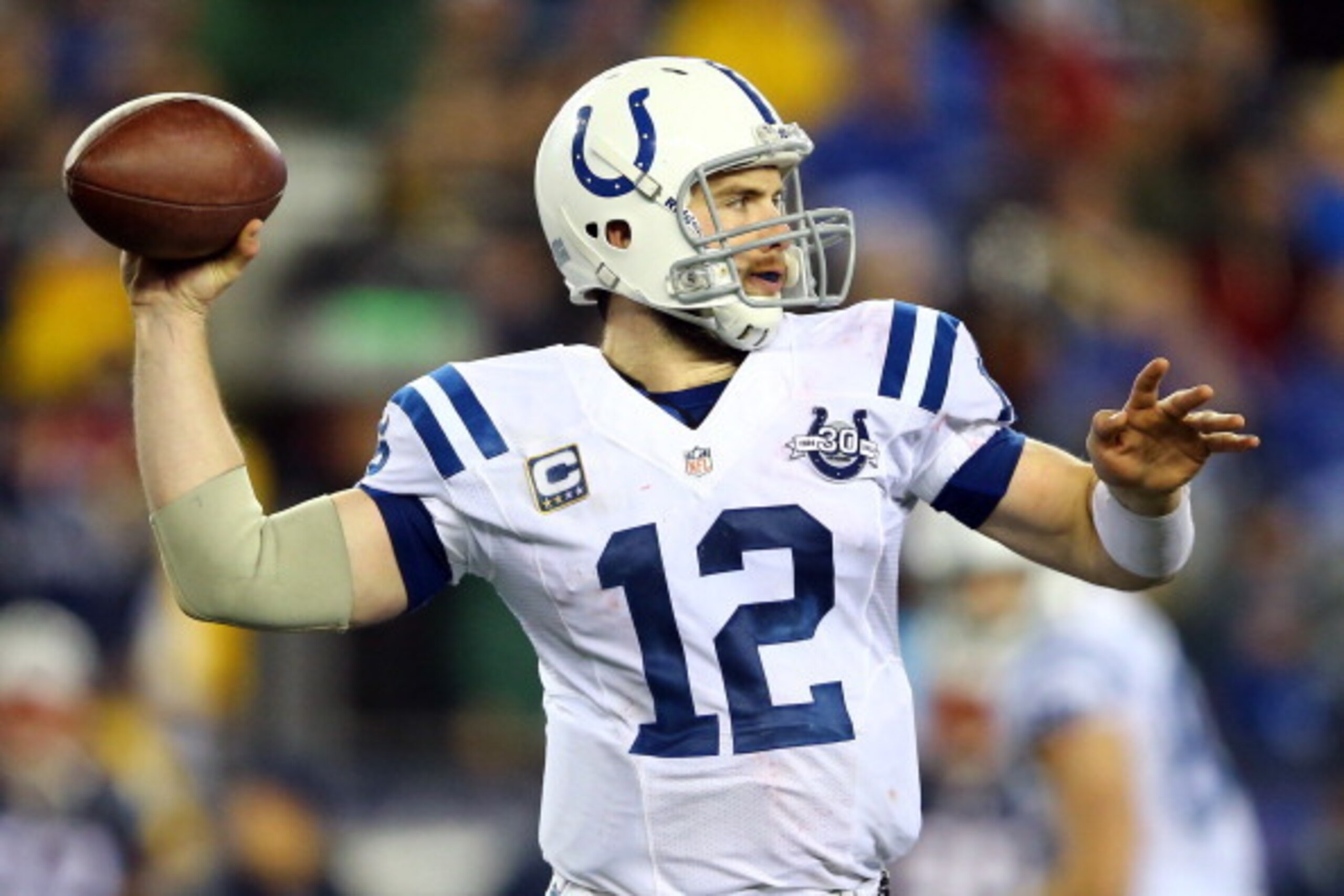 FOXBORO, MA - JANUARY 11:   Andrew Luck #12 of the Indianapolis Colts looks to throw a pass against the New England Patriots during the AFC Divisional Playoff game at Gillette Stadium on January 11, 2014 in Foxboro, Massachusetts.  (Photo by Al Bello/Gett