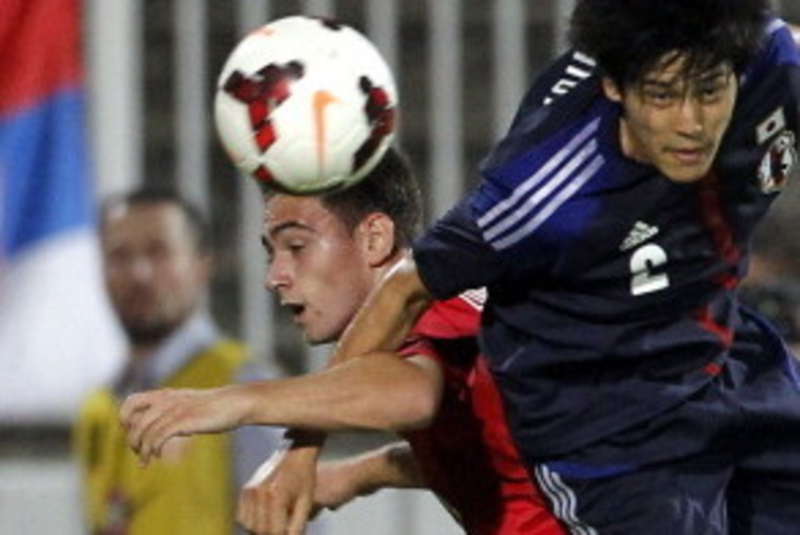 NOVI SAD, SERBIA - OCTOBER 11: Atsuto Uchida (R ) of Japan jumps for the ball with Andrija Zivkovic (L) of Serbia during an international friendly match between Serbia and Japan at stadium Karadjordje on October 11, 2013 in Novi Sad, Serbia (Photo by Srdj