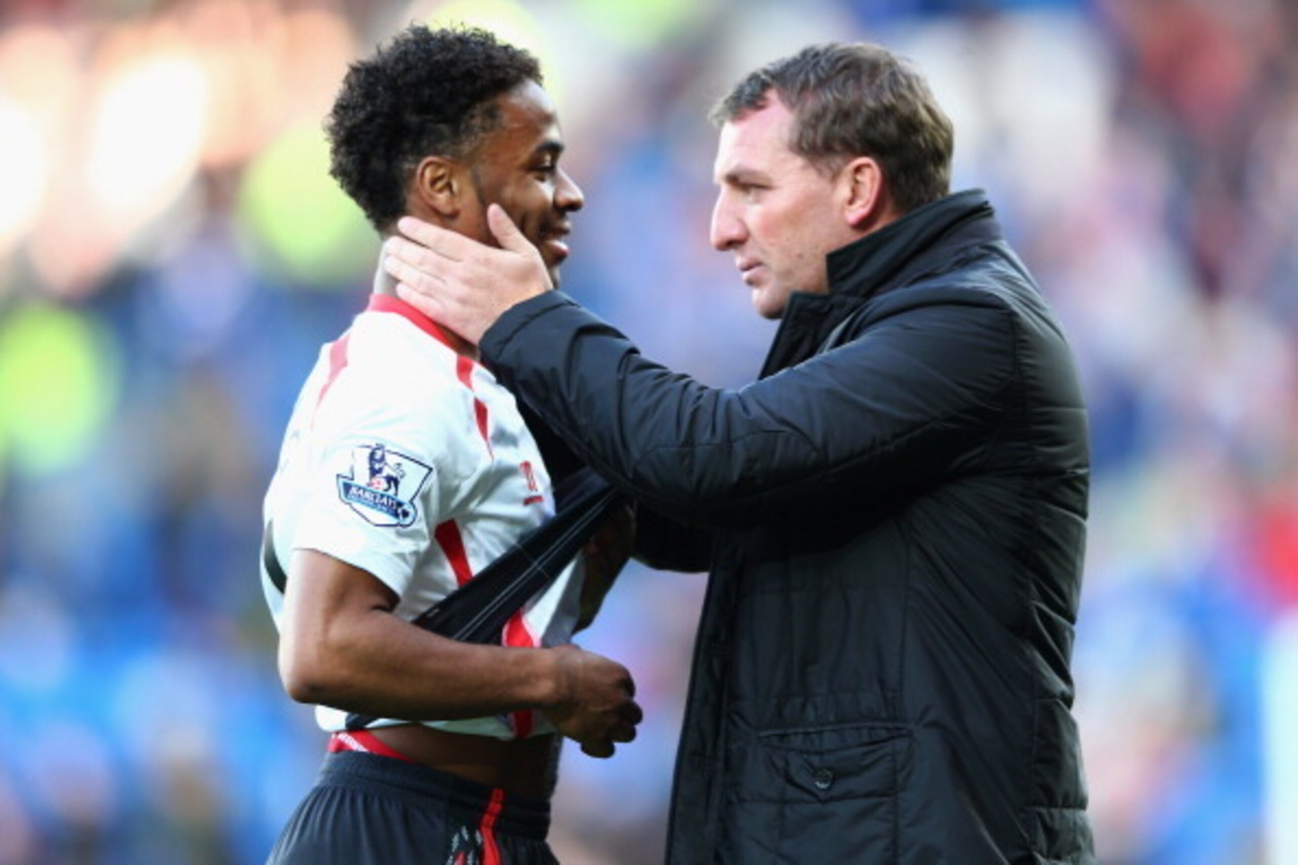 CARDIFF, WALES - MARCH 22:  Brendan Rodgers (R) the manager of Liverpool chats with Raheem Sterling after his side's 6-3 victory during the Barclays Premier League match between Cardiff City and Liverpool at the Cardiff City Stadium on March 22, 2014 in C