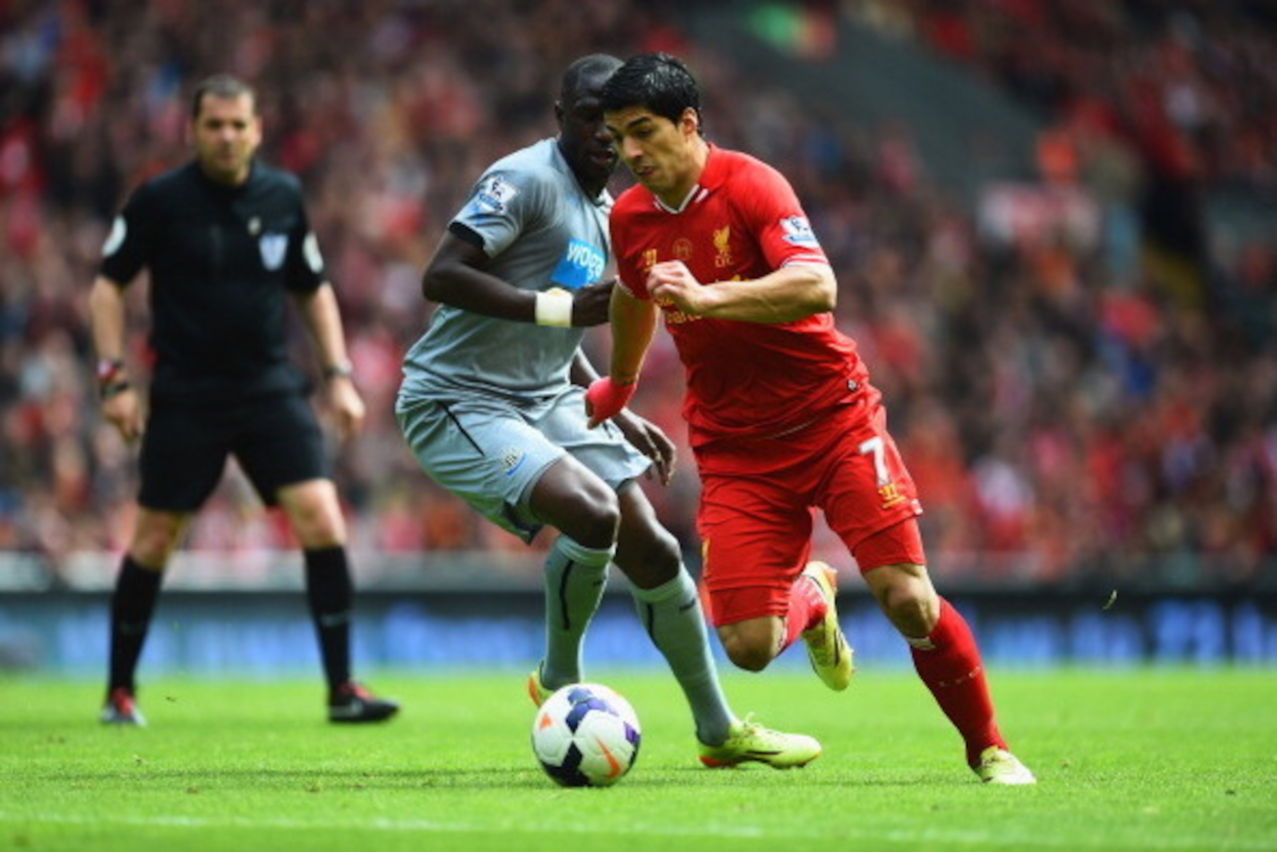 LIVERPOOL, ENGLAND - MAY 11:  Luis Suarez of Liverpool takes on Moussa Sissoko of Newcastle United during the Barclays Premier League match between Liverpool and Newcastle United at Anfield on May 11, 2014 in Liverpool, England.  (Photo by Laurence Griffi