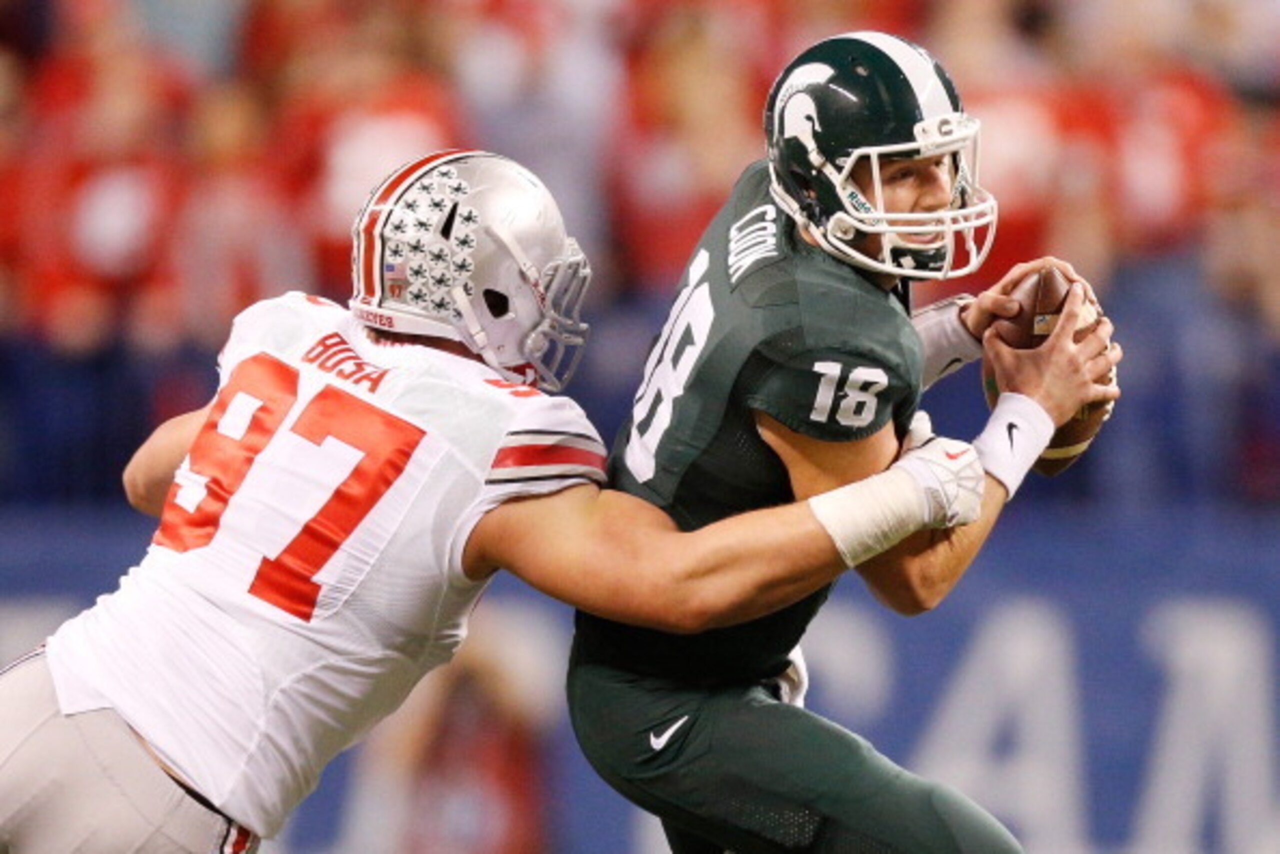 INDIANAPOLIS, IN - DECEMBER 07:  Joey Bosa #97 of the Ohio State Buckeyes sacks Connor Cook #18 of the Michigan State Spartans in the first quarter during the Big 10 Conference Championship Game at Lucas Oil Stadium on December 7, 2013 in Indianapolis, In