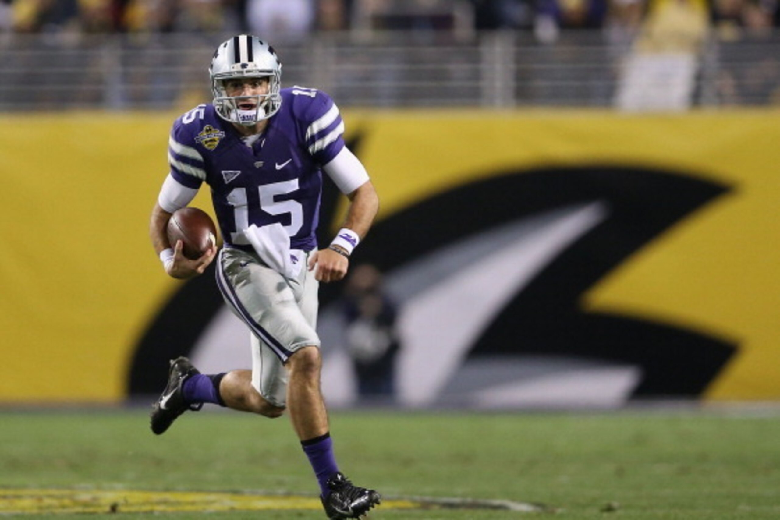 TEMPE, AZ - DECEMBER 28:  Quarterback Jake Waters #15 of the Kansas State Wildcats scrambles with the football during the first quarter of the Buffalo Wild Wings Bowl against the Michigan Wolverines at Sun Devil Stadium on December 28, 2013 in Tempe, Ariz