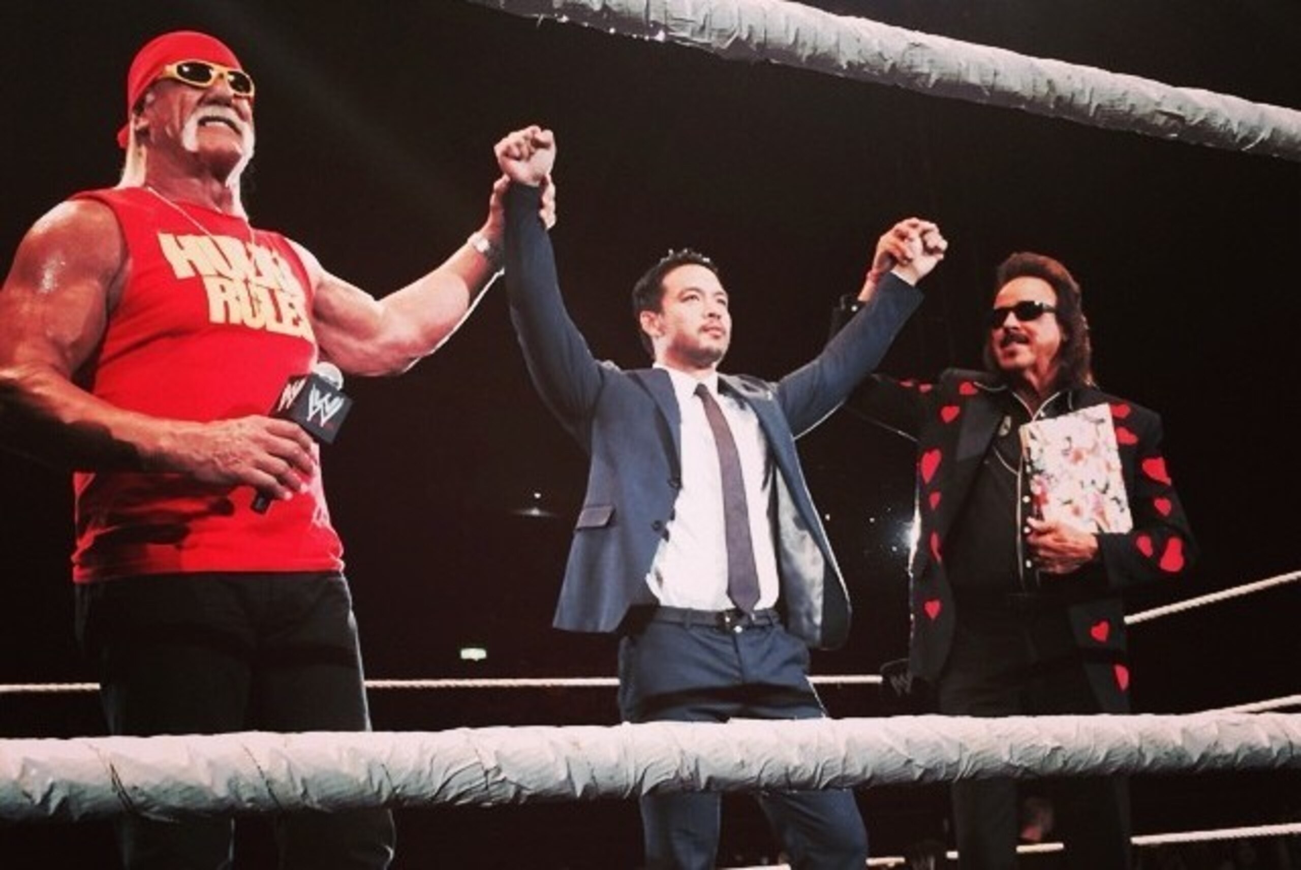 Hulk Hogan and Jimmy Hart welcome Kenta (middle) to WWE.