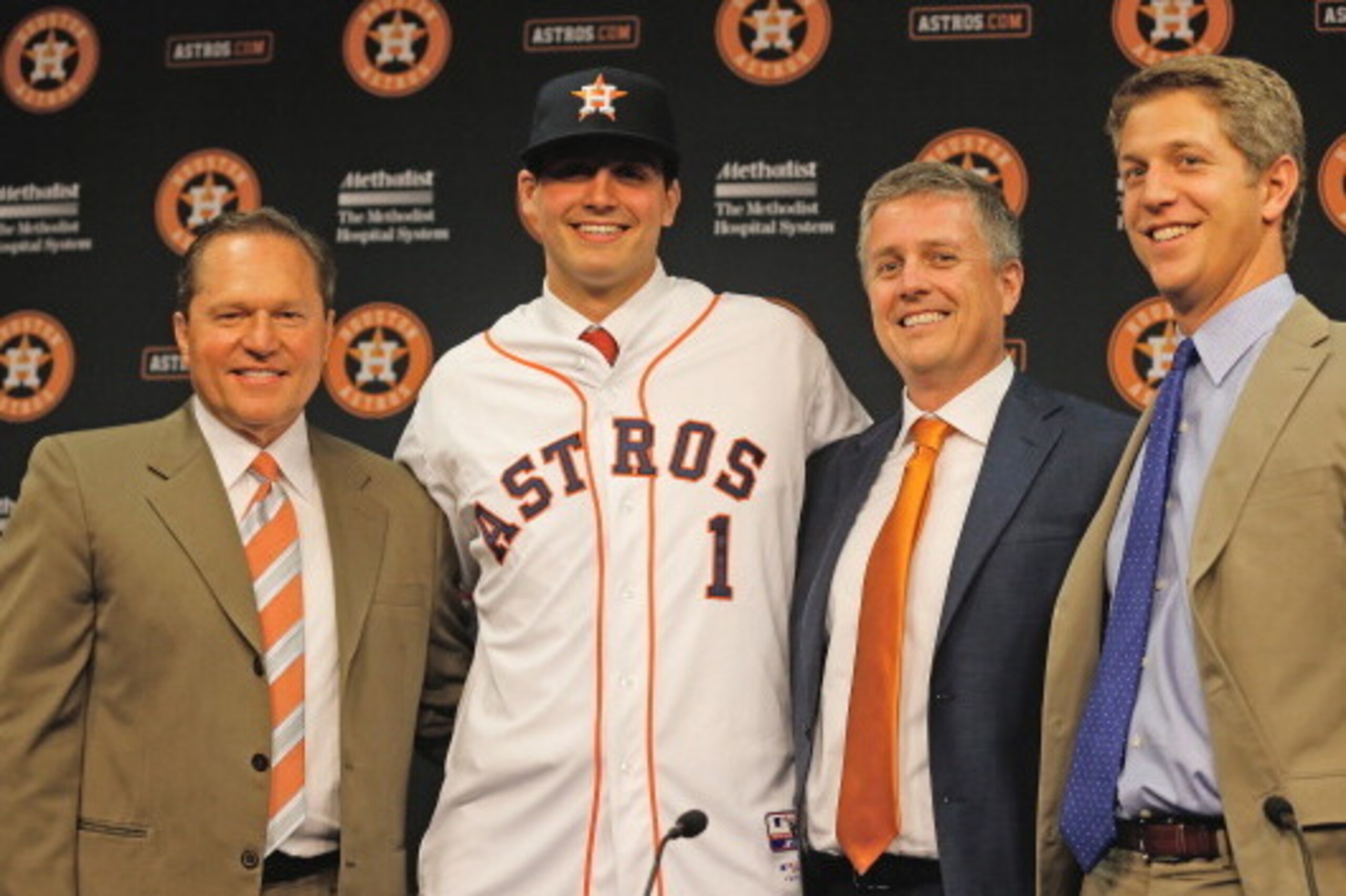 HOUSTON, TX - JUNE 19:  (L-R) Agent Scott Boras, Mark Appel, general managerJeff Luhnow and director of amateur scouting Mike Elias pose for the media after the Houston Astros signed first overall draft pick Appel to the team prior to the start of the gam