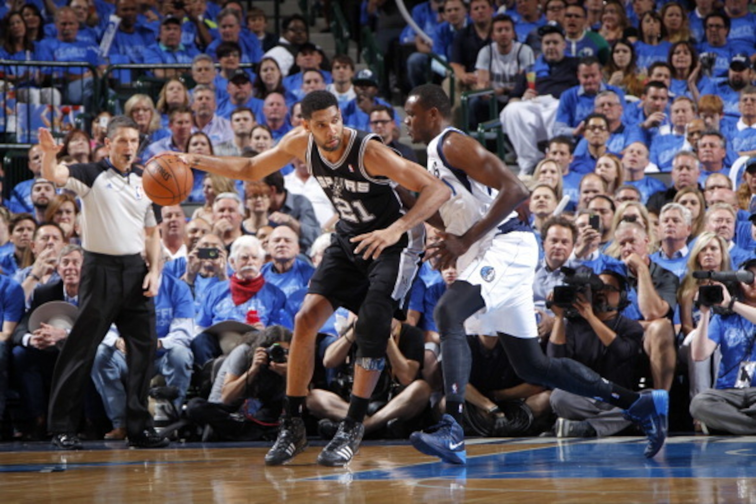 DALLAS, TX - APRIL 28: Tim Duncan #21 of the San Antonio Spurs controls the ball against Samuel Dalembert #1 of the Dallas Mavericks during Game Four of the Western Conference Quarterfinals during the 2014 NBA Playoffs on April 28, 2014 at the American Ai