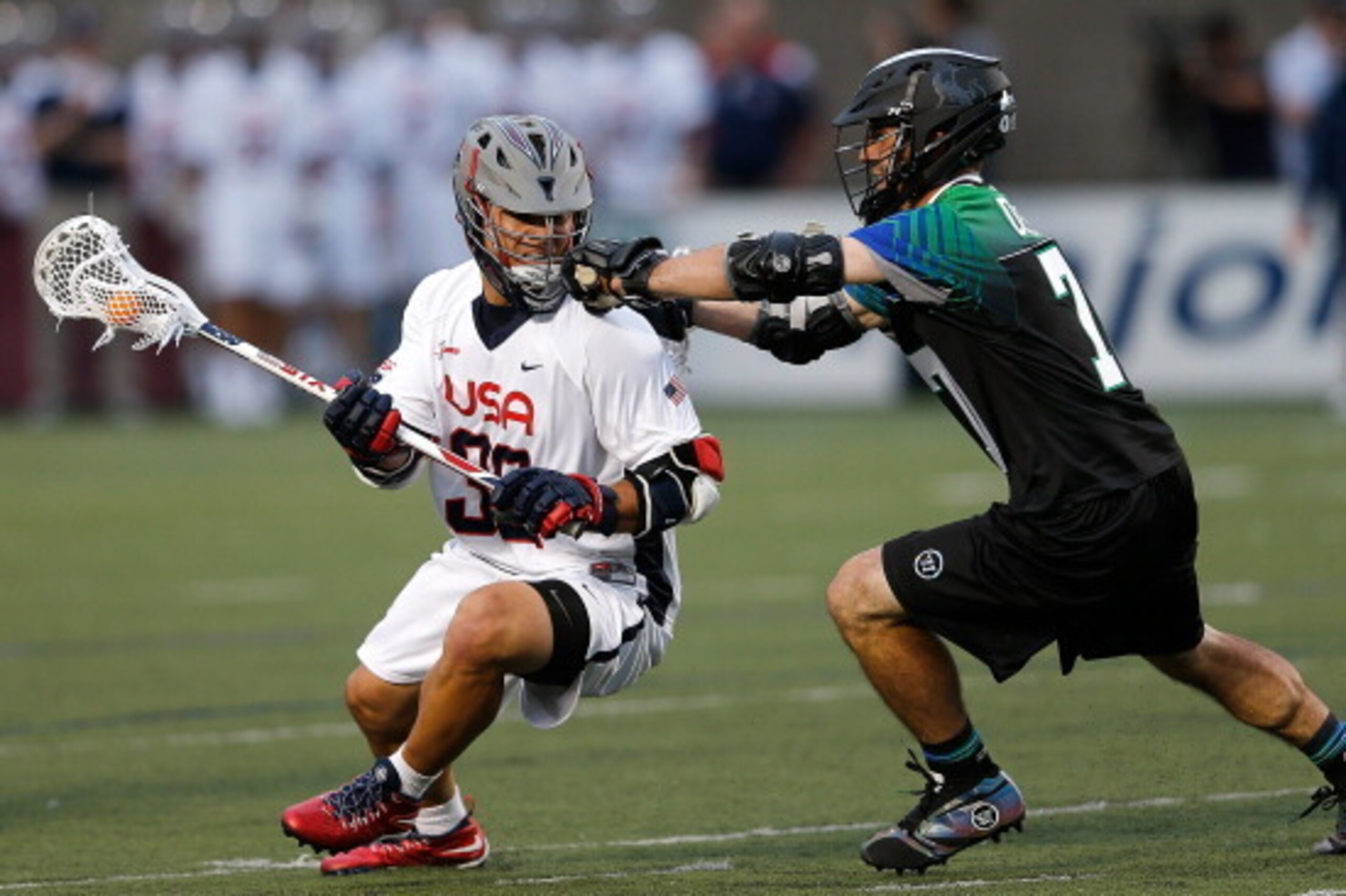 BOSTON, MA - JUNE 26: Rob Pannell #32 of Team USA battles Kyle Sweeney #77 of Team MLL in the first quarter during the 2014 MLL All Star Game at Harvard Stadium on June 26, 2014 in Boston, Massachusetts.  (Photo by Jim Rogash/Getty Images)
