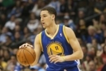 January 13, 2013; Denver, CO, USA; Golden State Warriors guard Klay Thompson (11) takes the ball up the court during the second half against the Denver Nuggets at the Pepsi Center.  The Nuggets won 116-105.  Mandatory Credit: Chris Humphreys-USA TODAY Spo
