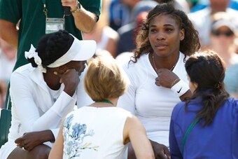 Venus Williams looks on at her sister, Serena Williams, during a medical timeout.