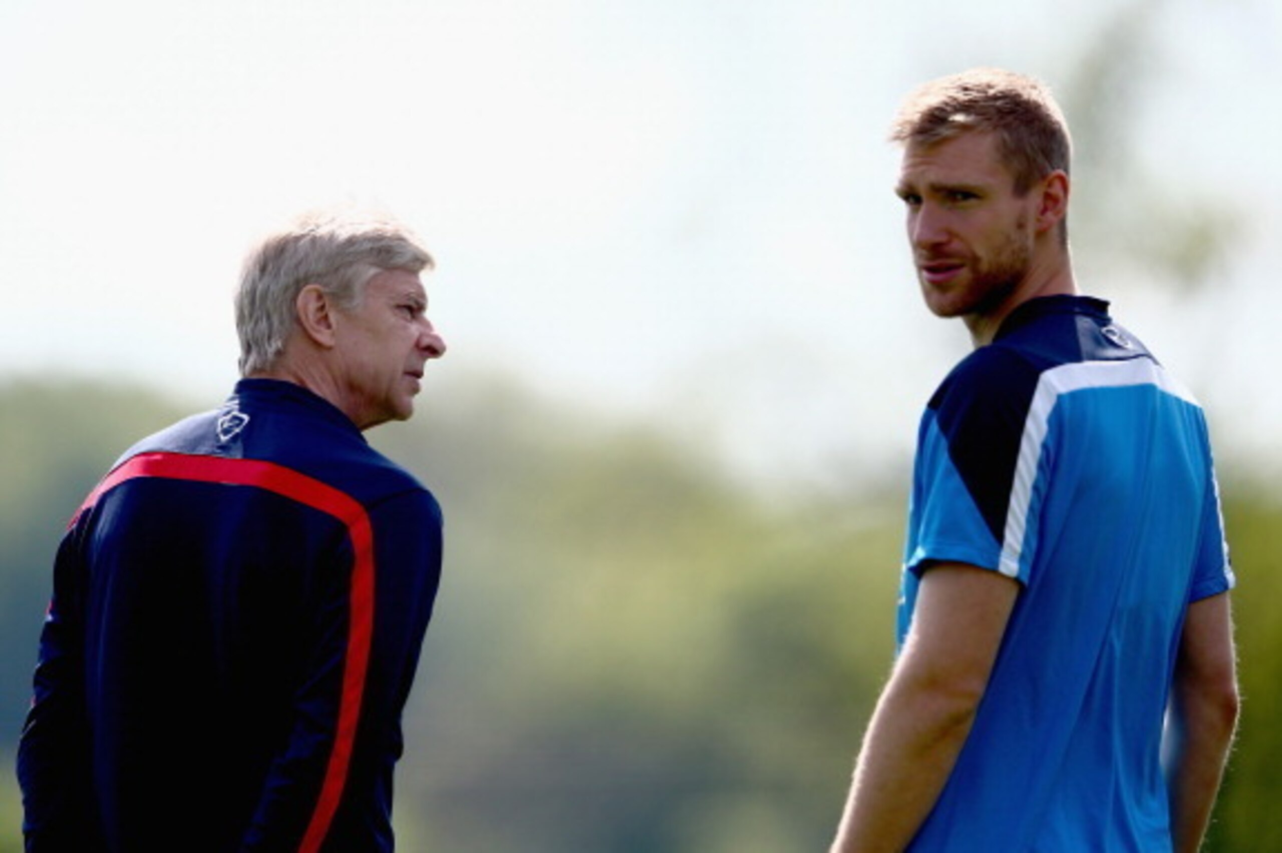 ST ALBANS, ENGLAND - MAY 14:  Arsene Wenger of Arsenal talks to Per Mertesacker of Arsenal during a training session ahead of the FA Cup Final match between Arsenal and Hull City at London Colney on May 14, 2014 in St Albans, England.  (Photo by Clive Mas