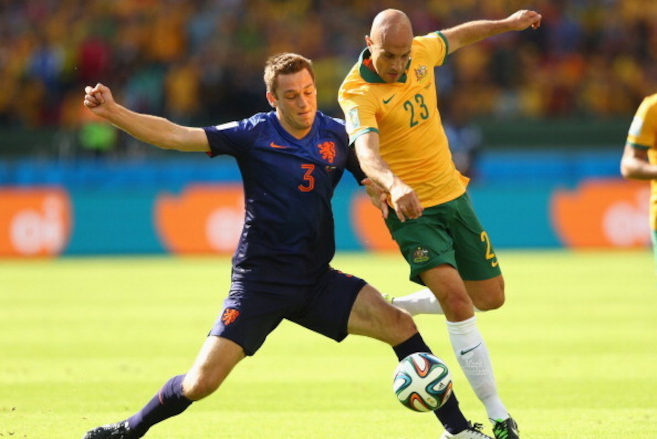 PORTO ALEGRE, BRAZIL - JUNE 18:  Stefan de Vrij of the Netherlands and Mark Bresciano of Australia compete for the ball during the 2014 FIFA World Cup Brazil Group B match between Australia and Netherlands at Estadio Beira-Rio on June 18, 2014 in Porto Al