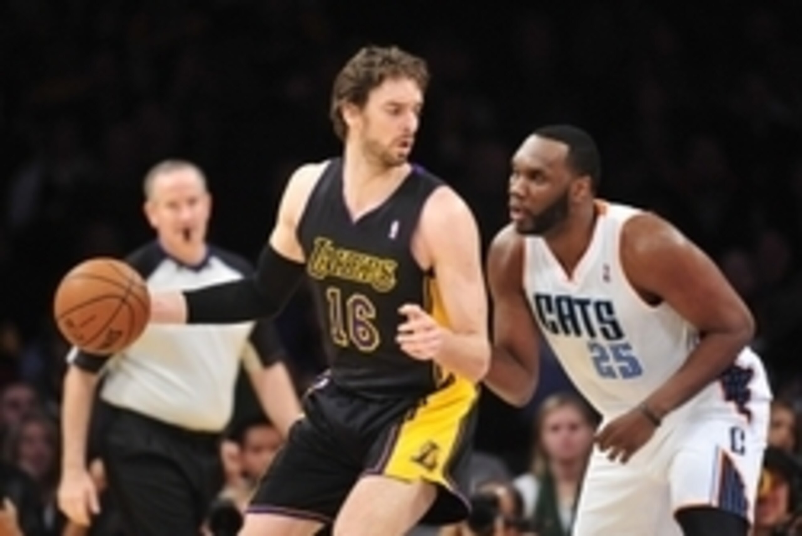 January 31, 2014; Los Angeles, CA, USA; Los Angeles Lakers center Pau Gasol (16) moves the ball against the defense of Charlotte Bobcats center Al Jefferson (25) during the first half at Staples Center. Mandatory Credit: Gary A. Vasquez-USA TODAY Sports