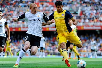 VALENCIA, SPAIN - APRIL 27:  Diego Costa of Club Atletico de Madrid competes for the ball Jeremy Mathieu of Valencia CF during the La Liga match between Valencia CF and Club Atletico de Madrid at Estadio Mestalla on April 27, 2014 in Valencia, Spain.  (Ph