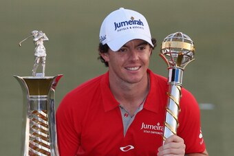 DUBAI, UNITED ARAB EMIRATES - NOVEMBER 25:  Rory McIlroy of Northern Ireland with the DP World Tour Championship and The Race to Dubai trophy on the 18th green during the final roung of the DP World Tour Championship on the Earth Course at Jumeirah Golf E