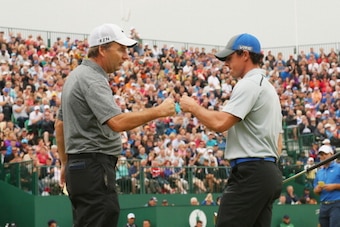 HOYLAKE, ENGLAND - JULY 19:  Rory McIlroy of Northern Ireland celebrates with his caddie J.P. Fitzgerald on the 18th green after shooting a four-under par 68 during the third round of The 143rd Open Championship at Royal Liverpool on July 19, 2014 in Hoyl