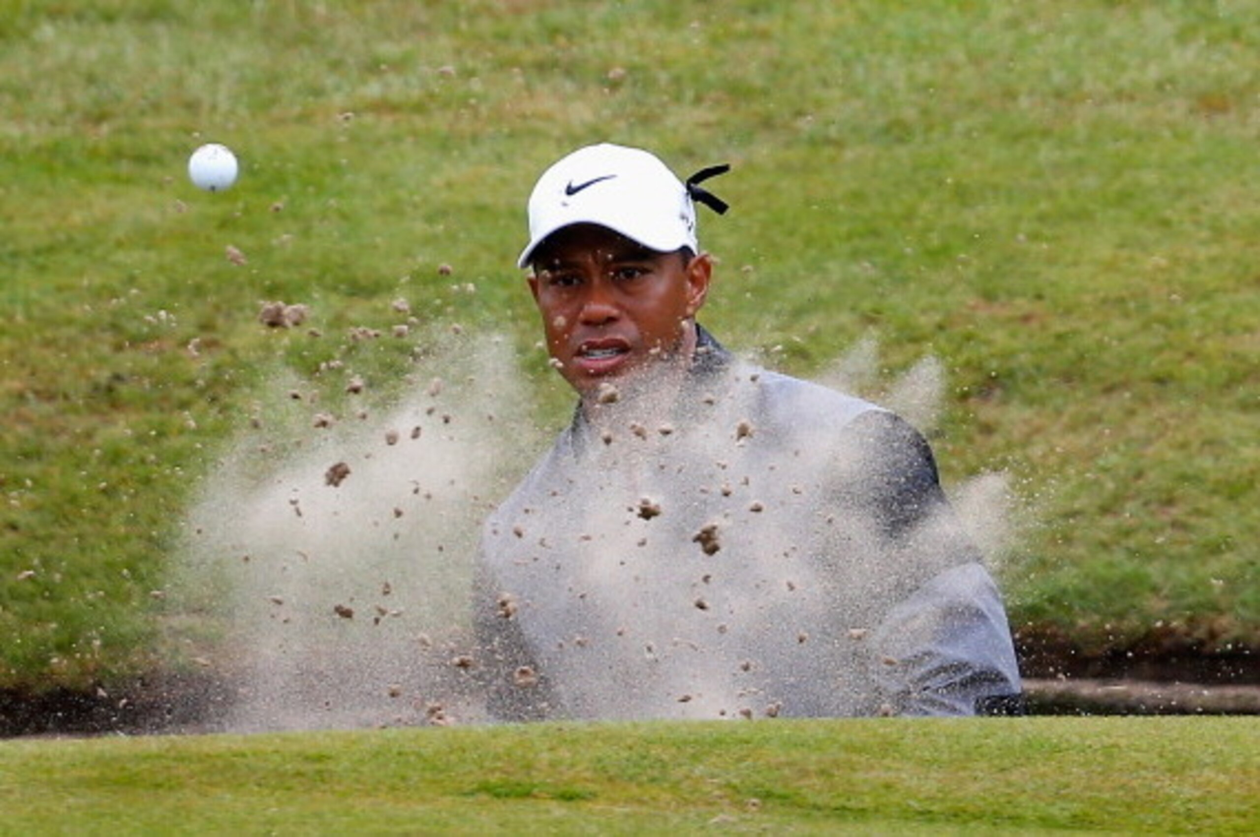 HOYLAKE, ENGLAND - JULY 19:  Tiger Woods of the United States hits from a bunker on the 15th hole during the third round of The 143rd Open Championship at Royal Liverpool on July 19, 2014 in Hoylake, England.  (Photo by Tom Pennington/Getty Images)