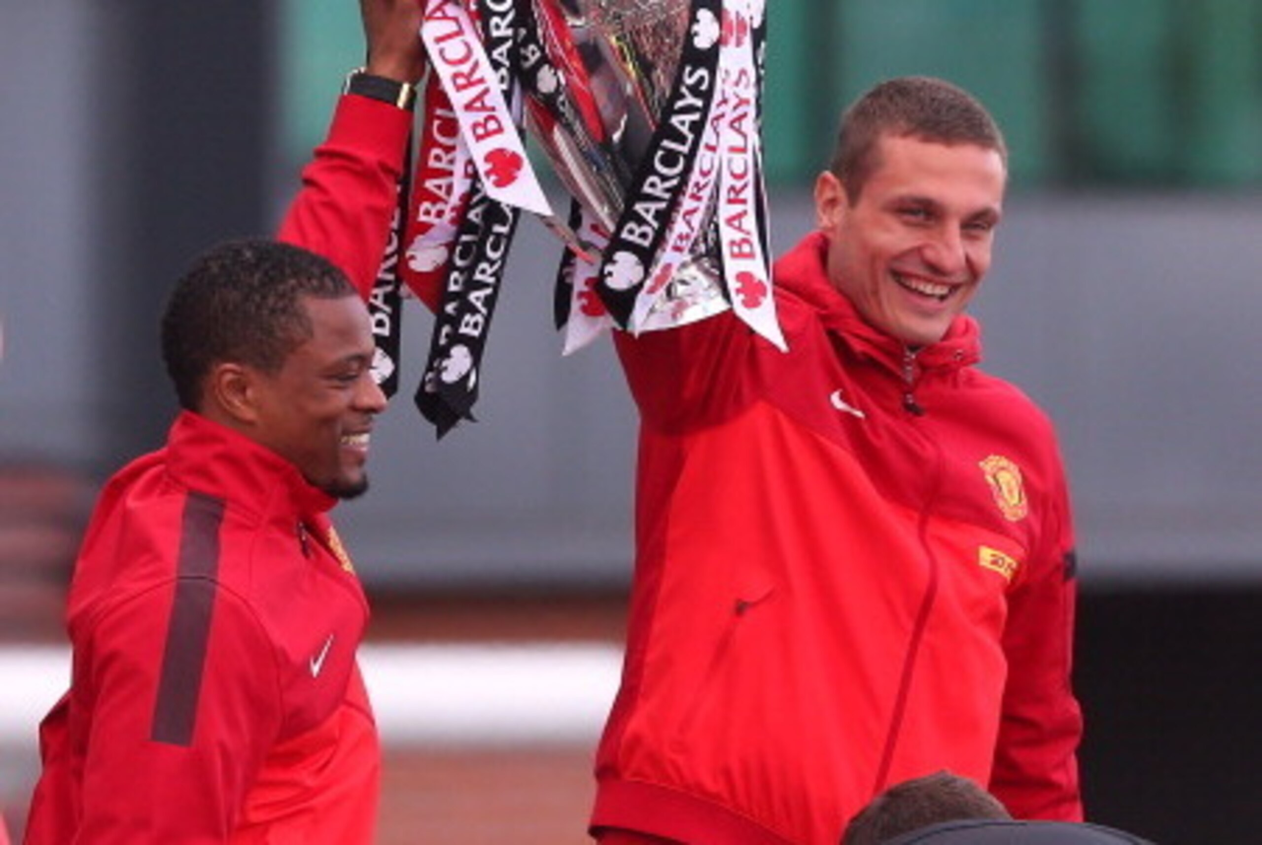MANCHESTER, ENGLAND - MAY 13:  Patrice Evra and Nemanja Vidic of Manchester United lift the Premier League trophy outside Old Trafford during the Manchester United Premier League Winners Parade on May 13, 2013 in Manchester, England.  (Photo by Alex Lives