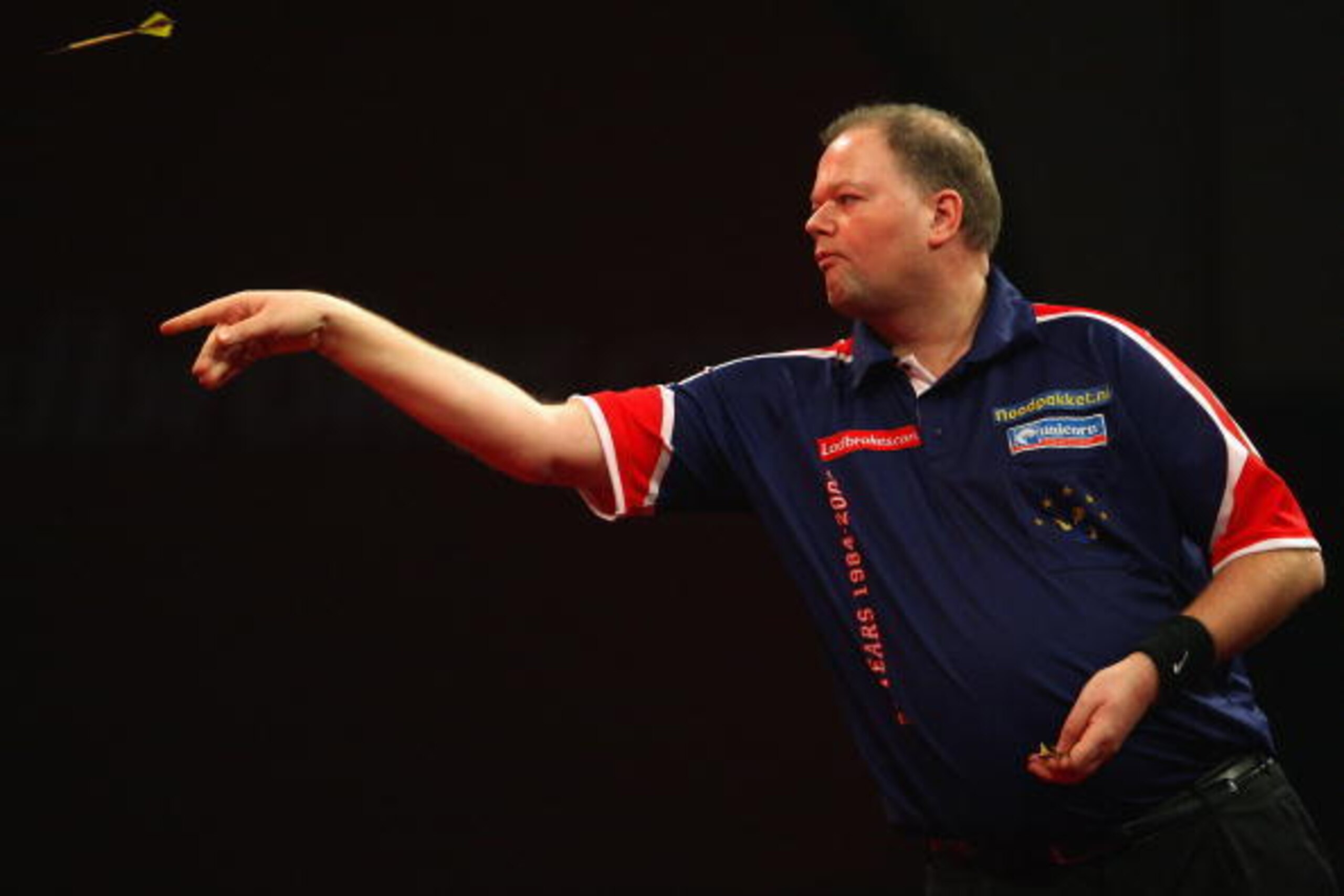 LONDON, ENGLAND - JANUARY 02:  Raymond Van Barneveld of Netherlands in action against Simon Whitlock of Australia in the Semi Finals of the 2010 Ladbrokes.com World Darts Championships at Alexandra Palace on January 2, 2010 in London, England.  (Photo by 