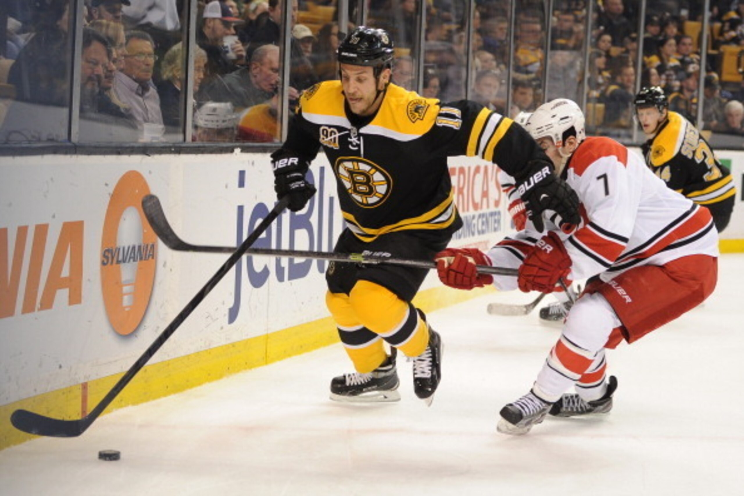 BOSTON, MA - MARCH 15: Gregory Campbell #11 of the Boston Bruins skates after the puck against Ryan Murphy #7 of the Carolina Hurricanes at the TD Garden on March 15, 2014 in Boston, Massachusetts. (Photo by Brian Babineau/NHLI via Getty Images) BOSTON, MA - MARCH 15: Gregory Campbell #11 of the Boston Bruins skates after the puck against Ryan Murphy #7 of the Carolina Hurricanes at the TD Garden on March 15, 2014 in Boston, Massachusetts. (Photo by Brian Babineau/NHLI via Getty Images)