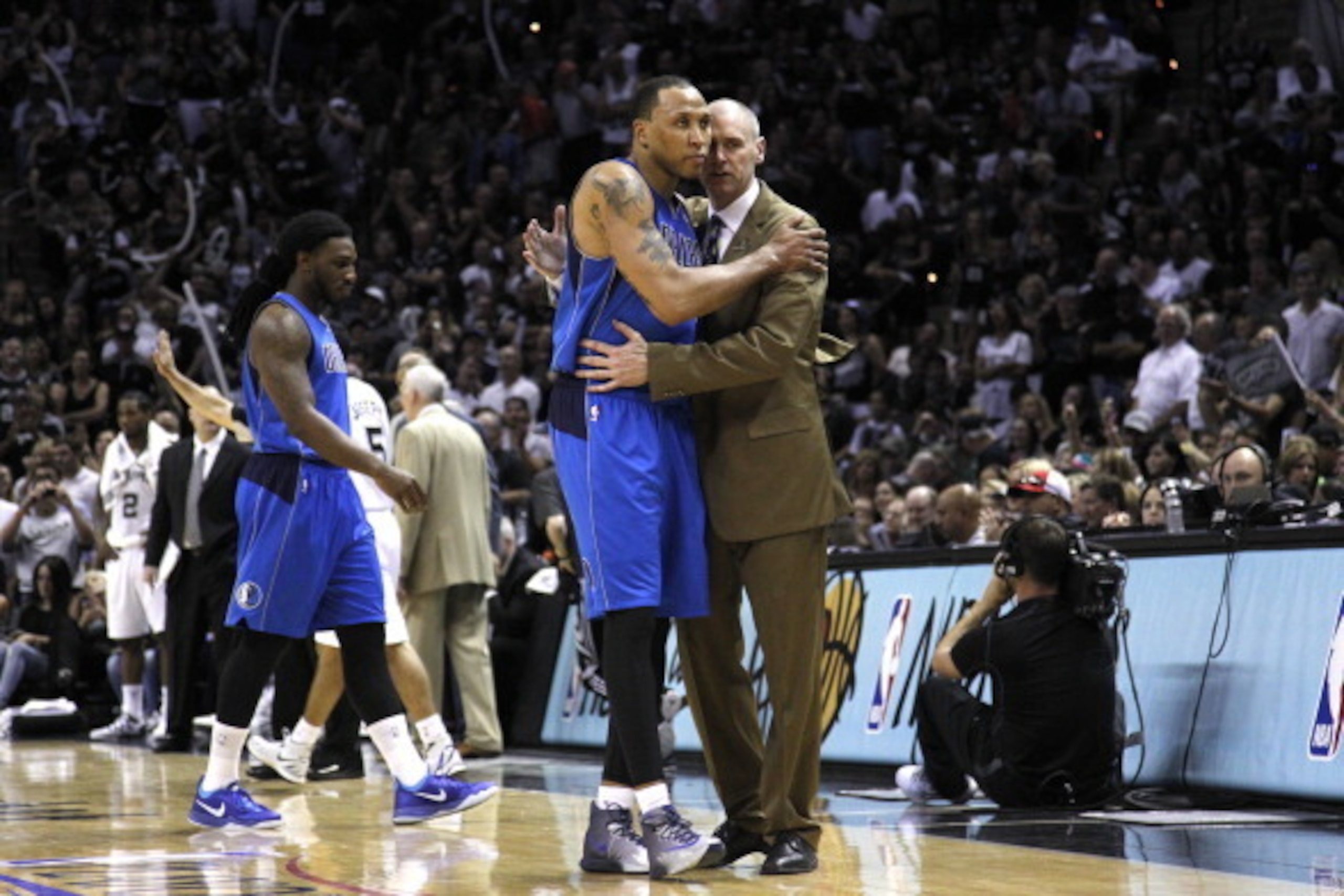 SAN ANTONIO, TX - MAY 4:  Head coach Rick Carlisle of the Dallas Mavericks and teammate Shawn Marion #0 hug as Marion leaves the court in the final minutes against the San Antonio Spurs in Game Seven of the Western Conference Quarterfinals during the 2014