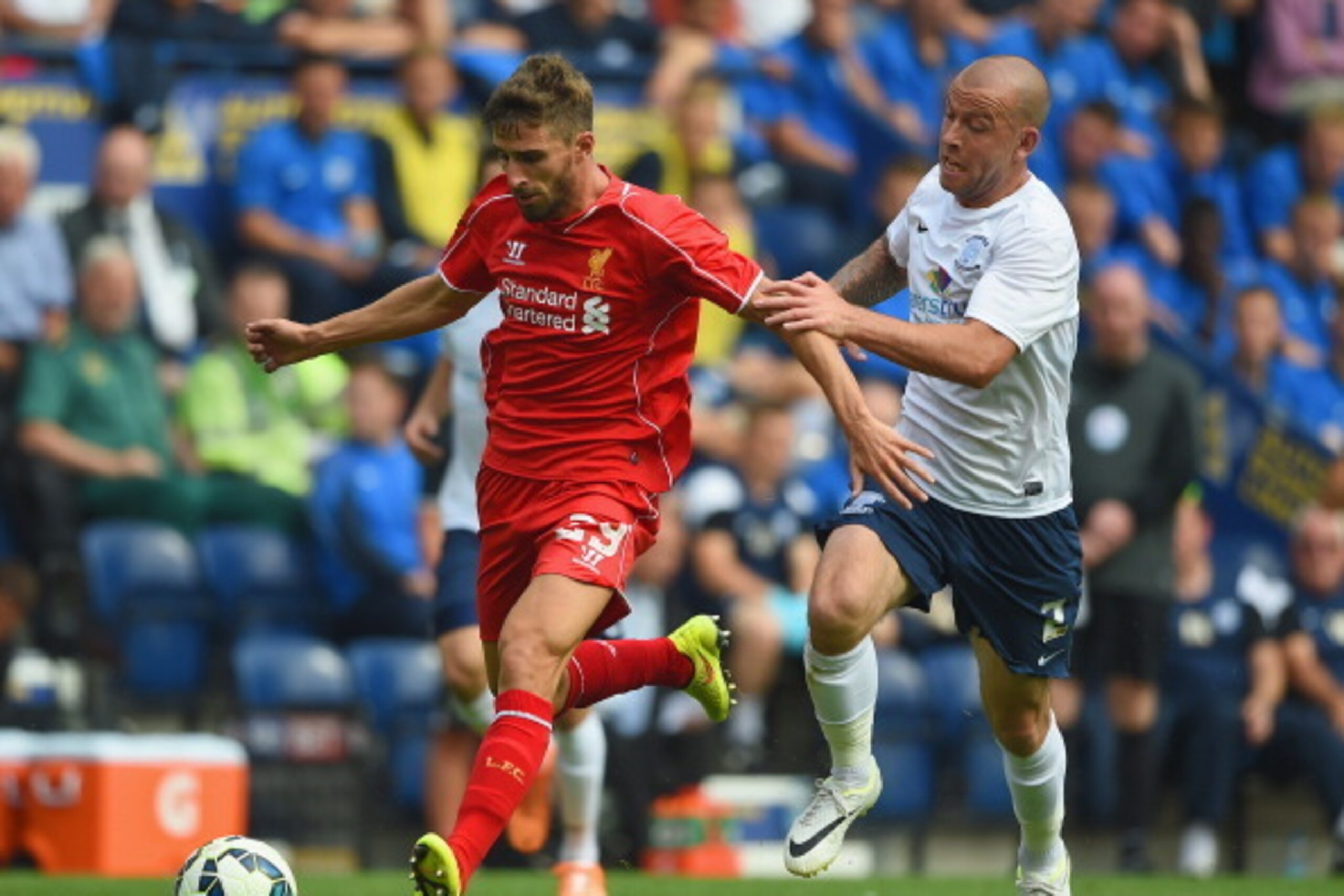 PRESTON, LANCASHIRE - JULY 19:  Keith Keane of Preston in action with Fabio Borini of Liverpool during the pre season friendly match between Preston North End and Liverpool at Deepdale on July 19, 2014 in Preston, Lancashire.  (Photo by Michael Regan/Gett