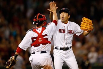 BOSTON, MA - JULY 19:  Koji Uehara #19 of the Boston Red Sox reacts with Christian Vazquez #55 after the final out against the Kansas City Royals to give the Red Sox a 2-1 win at Fenway Park on July 19, 2014 in Boston, Massachusetts.  (Photo by Jim Rogash