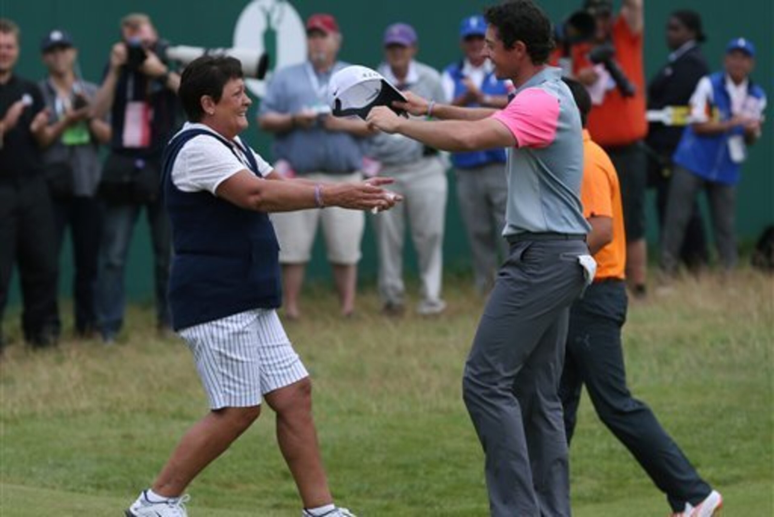 McIlroy celebrates with his mother on the 18th green.