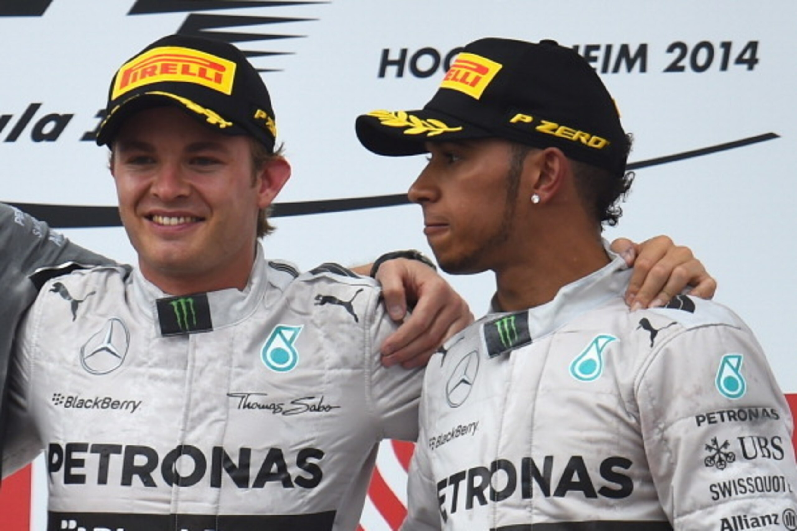 HOCKENHEIM, GERMANY - JULY 20:  Lewis Hamilton (L) of Great Britain and Mercedes GP seems to be looking towards his team mate Nico Rosberg of Germany and Mercedes GP as they celebrate their 1st and 3rd place positions in the German Grand Prix at Hockenhei