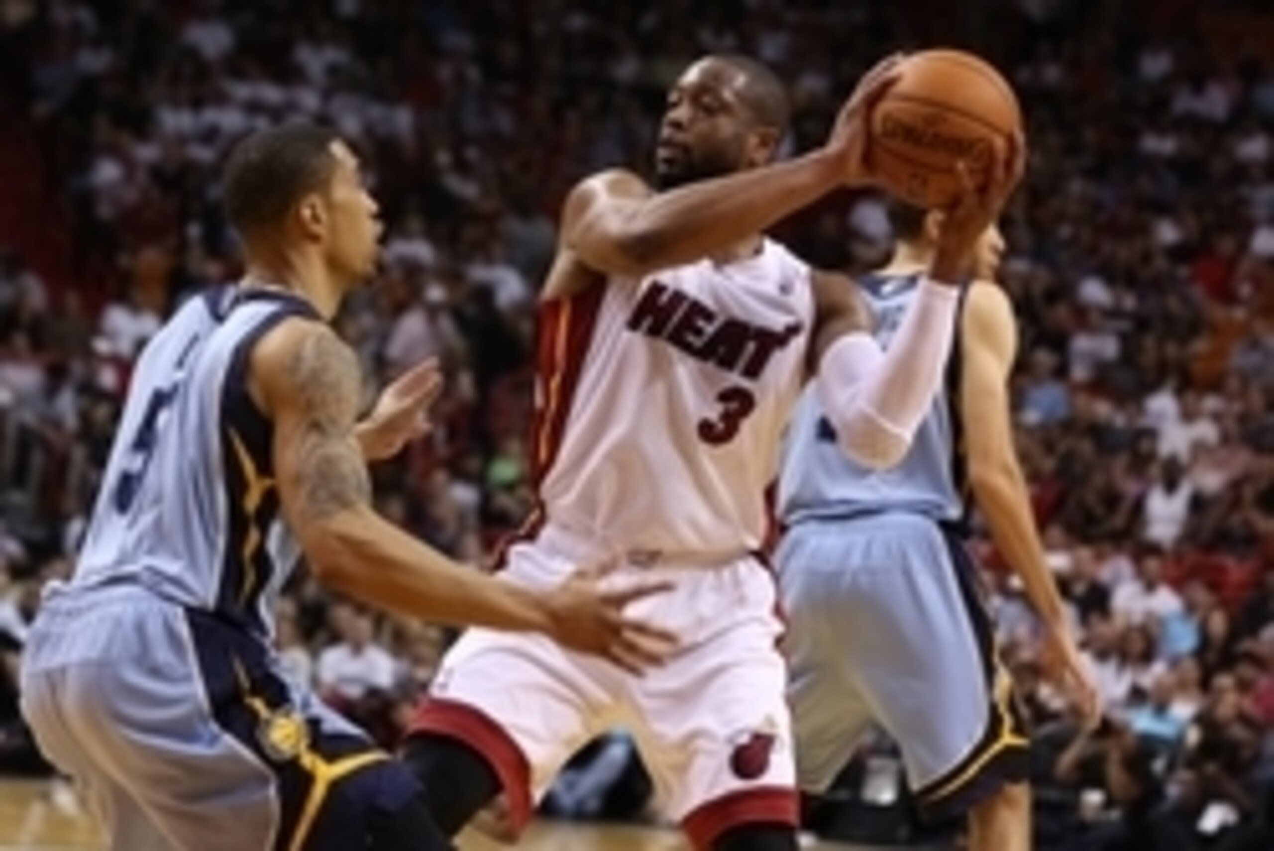 Mar 21, 2014; Miami, FL, USA;  Miami Heat guard Dwyane Wade (3) looks to pass the ball as Memphis Grizzlies guard Courtney Lee (5) defends in the second half at American Airlines Arena. The Heat won 91-88. Mandatory Credit: Robert Mayer-USA TODAY Sports