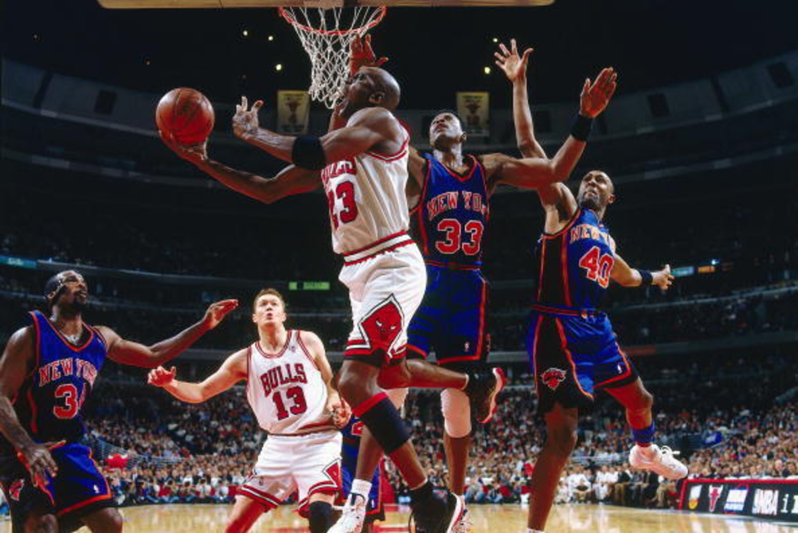 CHICAGO - MAY 14:  Michael Jordan #23 of the Chicago Bulls takes a reverse layup against Patrick Ewing #33 of the New York Knicks in Game five of the Eastern Conference Semifinals during the 1996 NBA Playoffs at the United Center on May 14, 1996 in Chicag