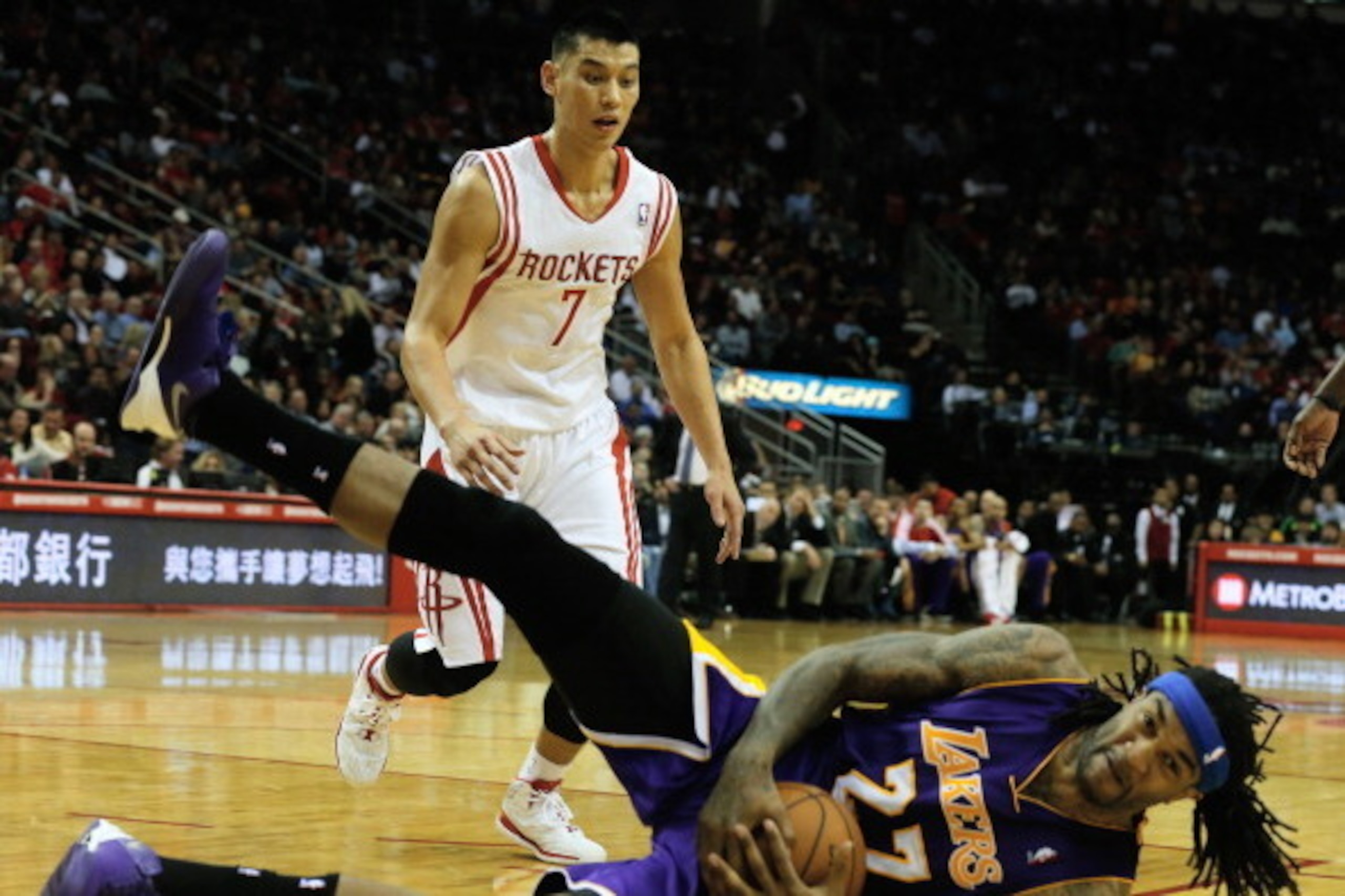 HOUSTON, TX - JANUARY 08:  Jeremy Lin #7 of the Houston Rockets looks down to Jordan Hill #27 of the Los Angeles Lakers during the game at the Toyota Center on January 8, 2014 in Houston, Texas. NOTE TO USER: User expressly acknowledges and agrees that, b