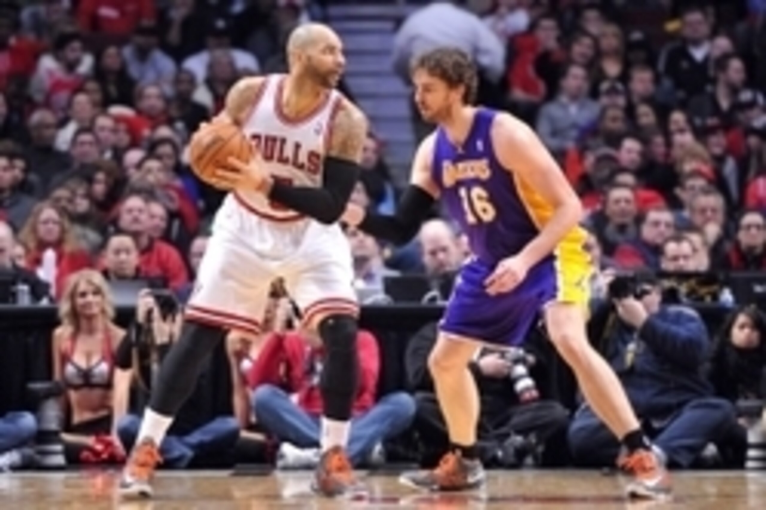 Jan 21, 2013; Chicago, IL, USA; Chicago Bulls power forward Carlos Boozer (5) is defended by Los Angeles Lakers power forward Pau Gasol (16) during the second half at the United Center. The Bulls beat the Lakers 95-83.  Mandatory Credit: Rob Grabowski-USA