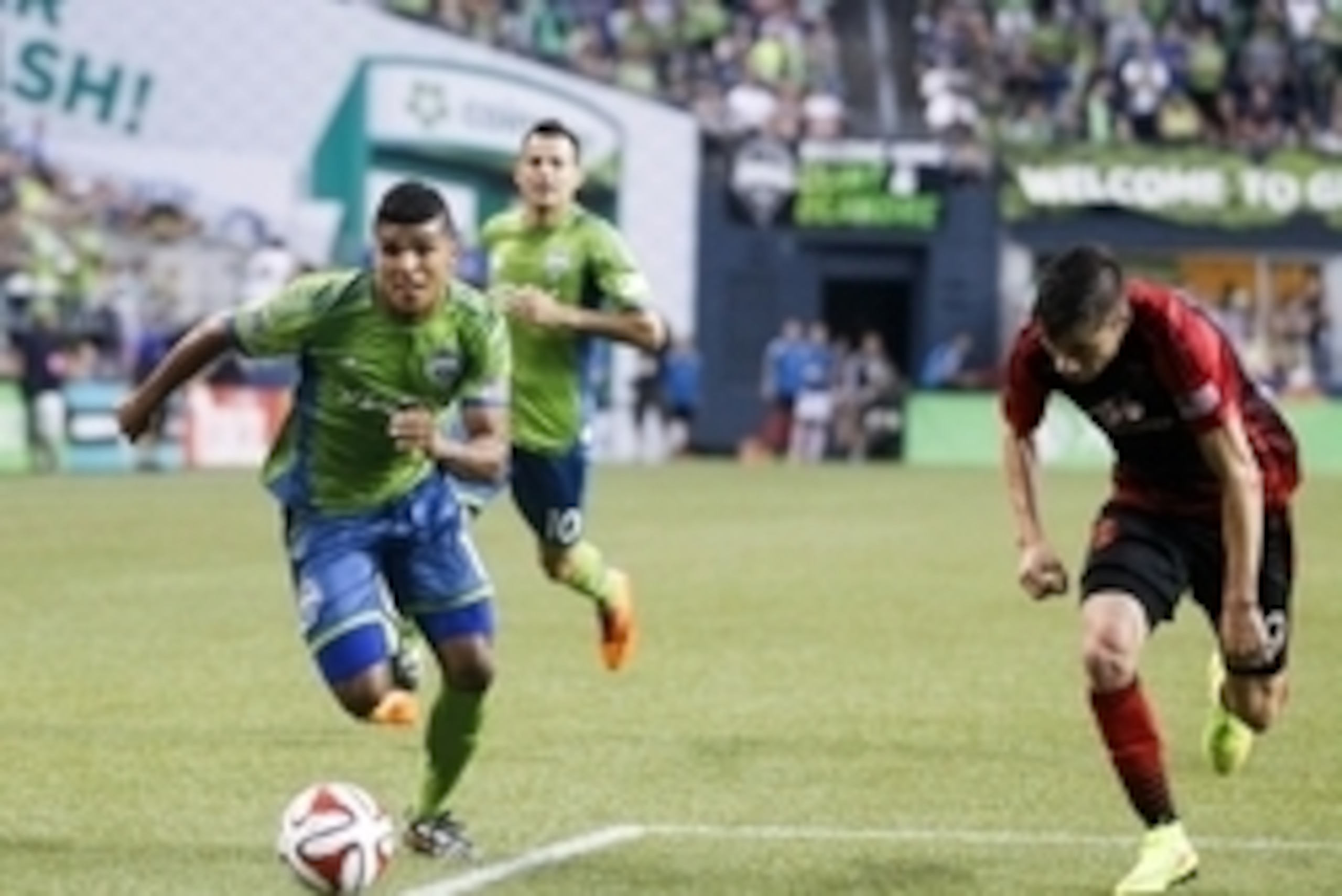 Jul 13, 2014; Seattle, WA, USA;  Seattle Sounders FC defender DeAndre Yedlin (17) attacks the Portland Timbers defense during the second half at CenturyLink Field. Mandatory Credit: Joe Nicholson-USA TODAY Sports