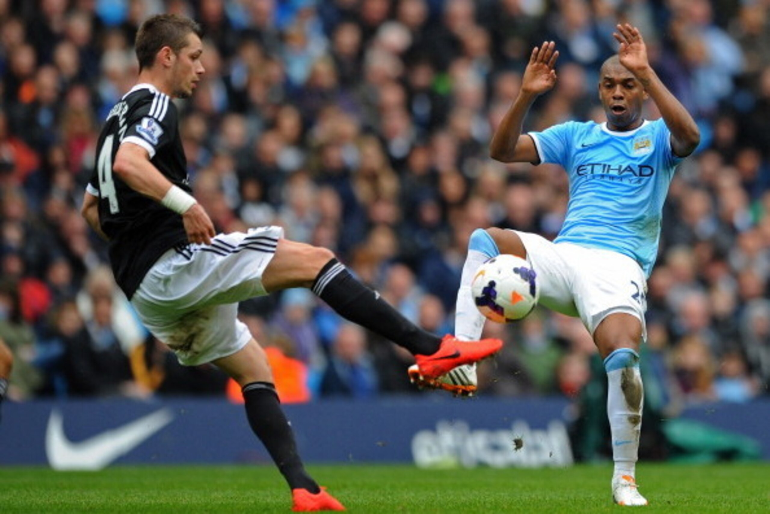 MANCHESTER, ENGLAND - APRIL 05:  Morgan Schneiderlin of Southampton and Fernandinho of Manchester City compete for the ball during the Barclays Premier League match between Manchester City and Southampton at Etihad Stadium on April 5, 2014 in Manchester, 
