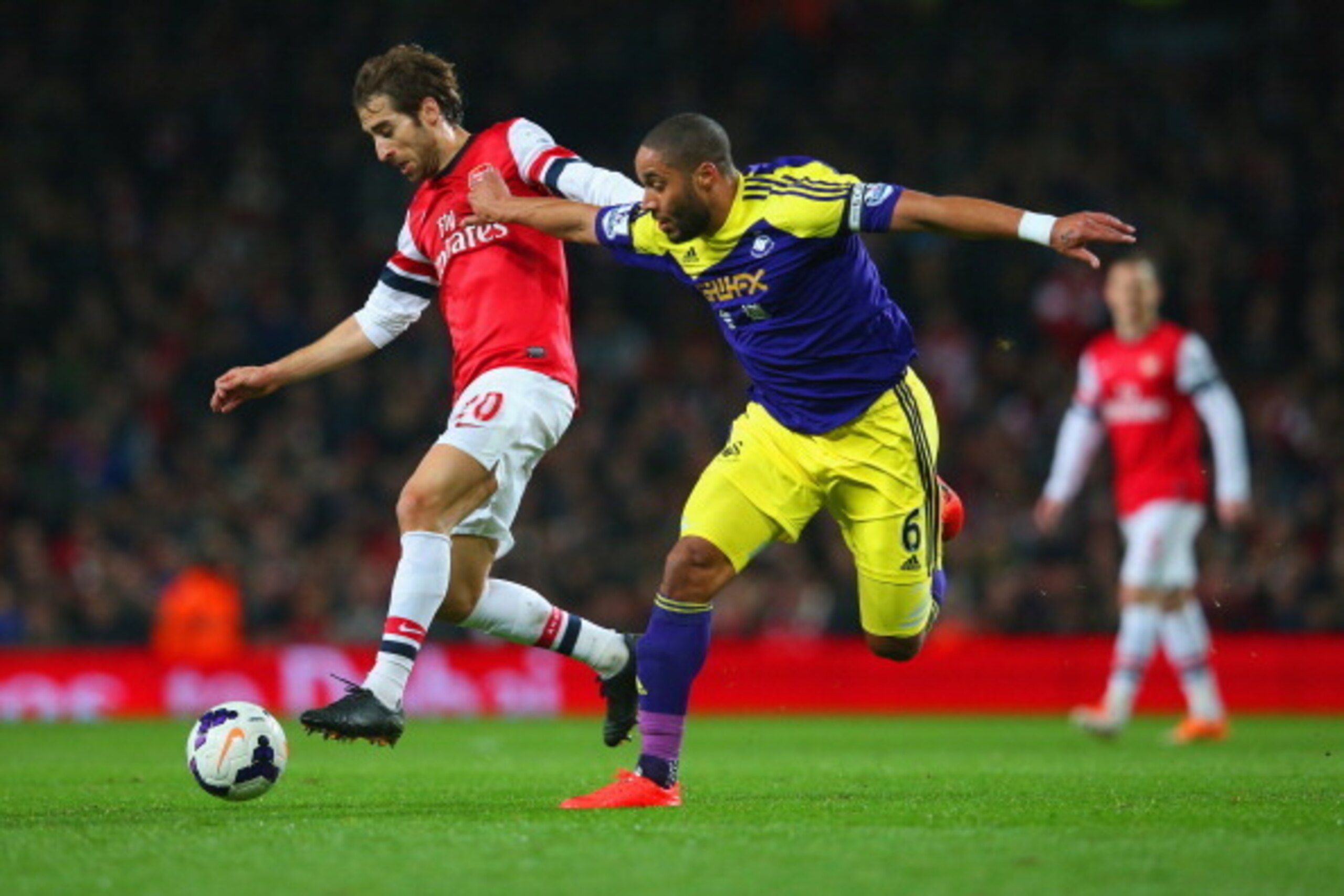 LONDON, ENGLAND - MARCH 25:  Mathieu Flamini of Arsenal and Ashley Williams of Swansea City battle for the ball during the Barclays Premier League match between Arsenal and Swansea City at Emirates Stadium on March 25, 2014 in London, England.  (Photo by 