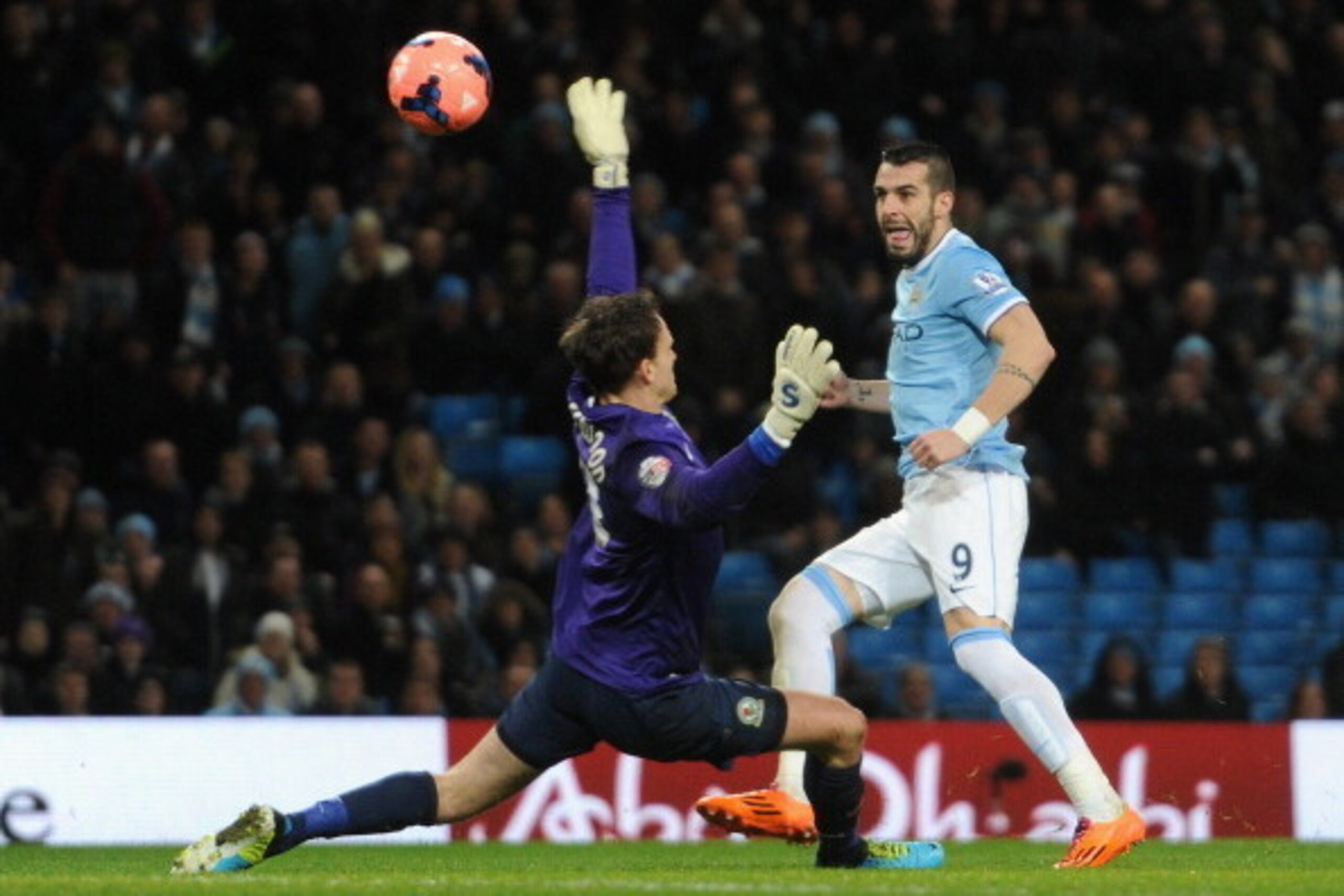 MANCHESTER, ENGLAND - JANUARY 15:  Alvaro Negredo of Manchester City scores the second goal past Simon Eastwood of Blackburn Rovers during the Budweiser FA Cup Third Round Replay match between Manchester City and Blackburn Rovers at the Etihad Stadium on 