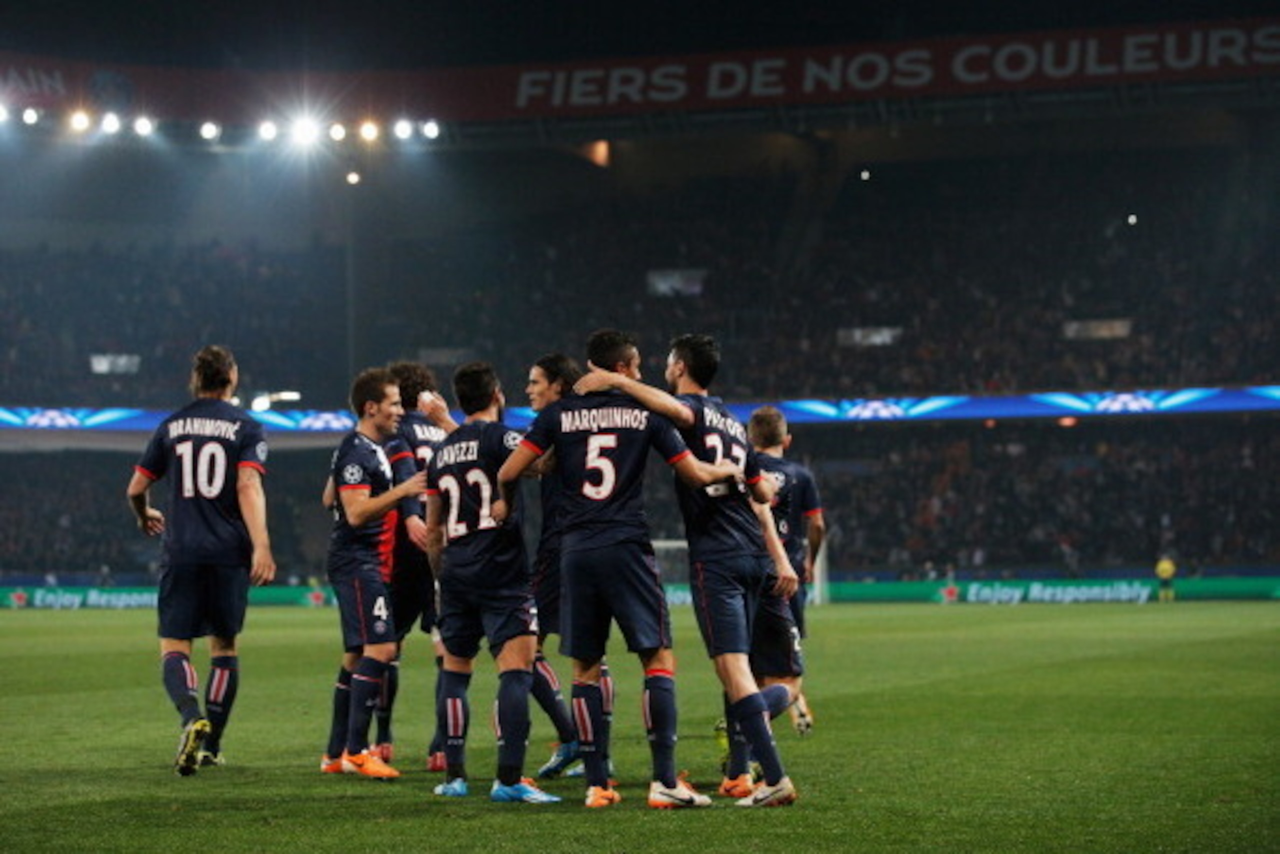 PARIS, FRANCE - MARCH 12:  Despair for Bayer Leverkusen players as Marquinhos of Paris Saint-Germain (5) celebrates with team mates as he scores their first goal during the UEFA Champions League Round of 16 second leg match between Paris Saint-Germain FC 