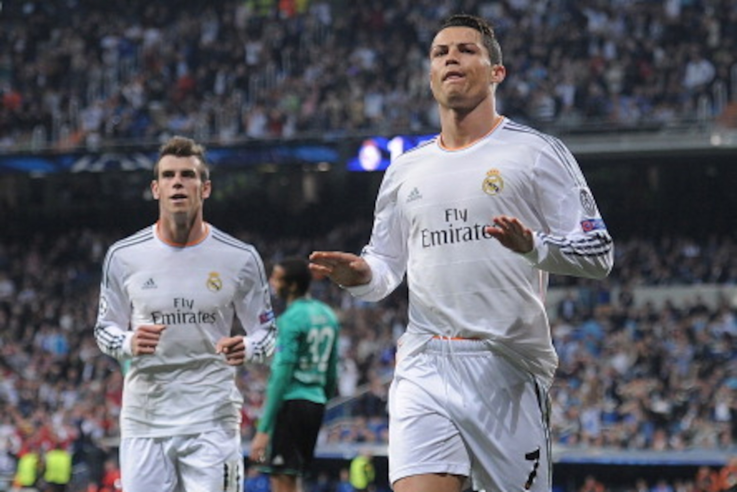 MADRID, SPAIN - MARCH 18: Cristiano Ronaldo (R) of Real Madrid celebrates with teammate Gareth Bale after scoring his team's second goal during the UEFA Champions League Round of 16, second leg match between Real Madrid and FC Schalke 04 at Estadio Santia