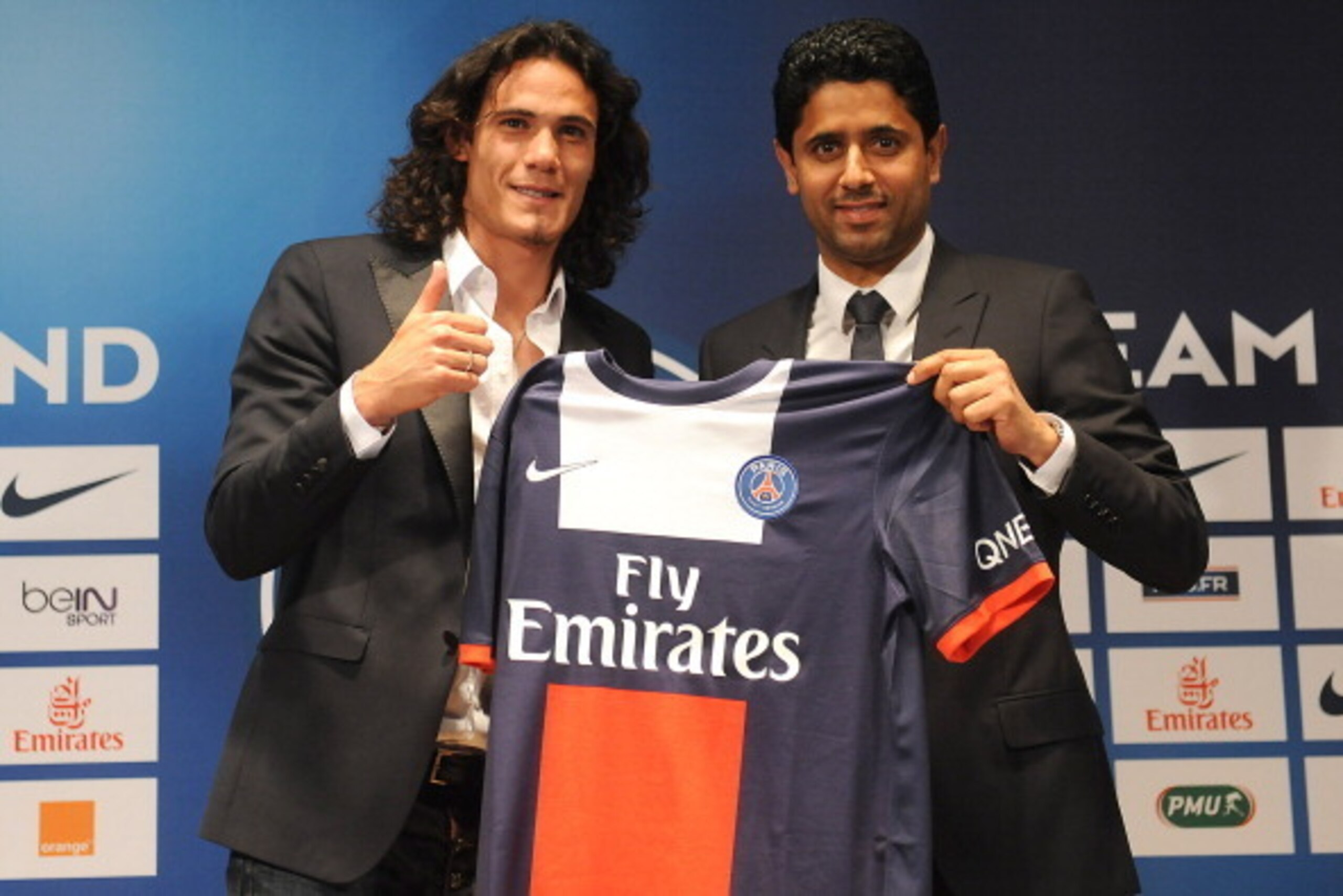 PARIS, FRANCE - JULY 16:  Paris Saint-Germain's (PSG) new forward, Edinson Cavani (L), and Paris Saint-Germain's (PSG) chairman Nasser Al-Khelaifi, pose with Cavani's jersey during a press conference on July 16, 2013 in Paris, France. Cavani's transfer to