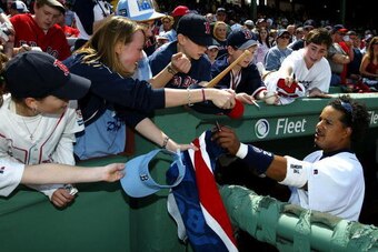 BOSTON - APRIL 17:  Manny Ramirez #24 of the Boston Red Sox signs autographs before their game against the New York Yankees on April 17, 2004 at Fenway Park in Boston, Massachusetts. The Red Sox won 5-2.  (Photo by Ezra Shaw/Getty Images)