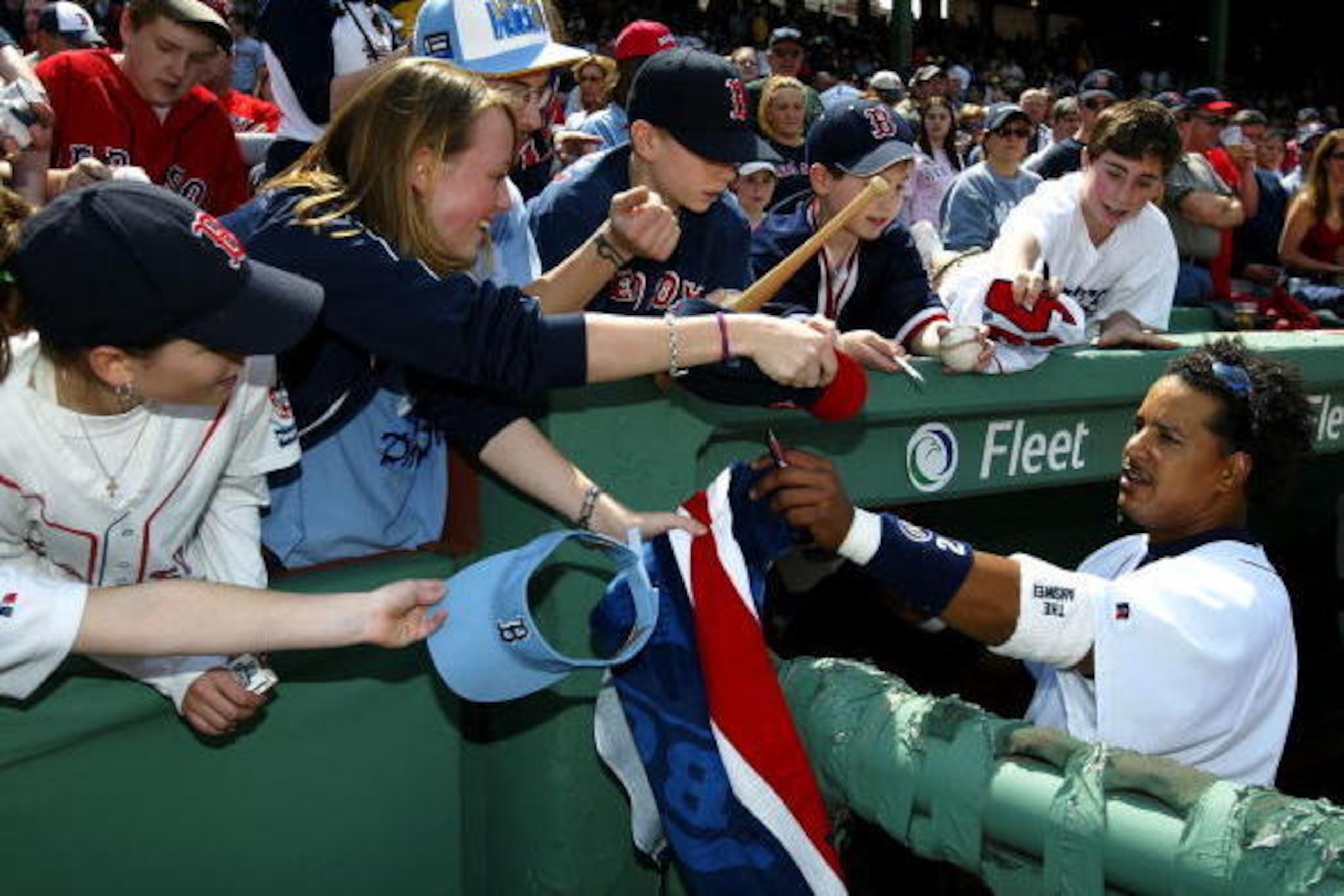 BOSTON - APRIL 17:  Manny Ramirez #24 of the Boston Red Sox signs autographs before their game against the New York Yankees on April 17, 2004 at Fenway Park in Boston, Massachusetts. The Red Sox won 5-2.  (Photo by Ezra Shaw/Getty Images)
