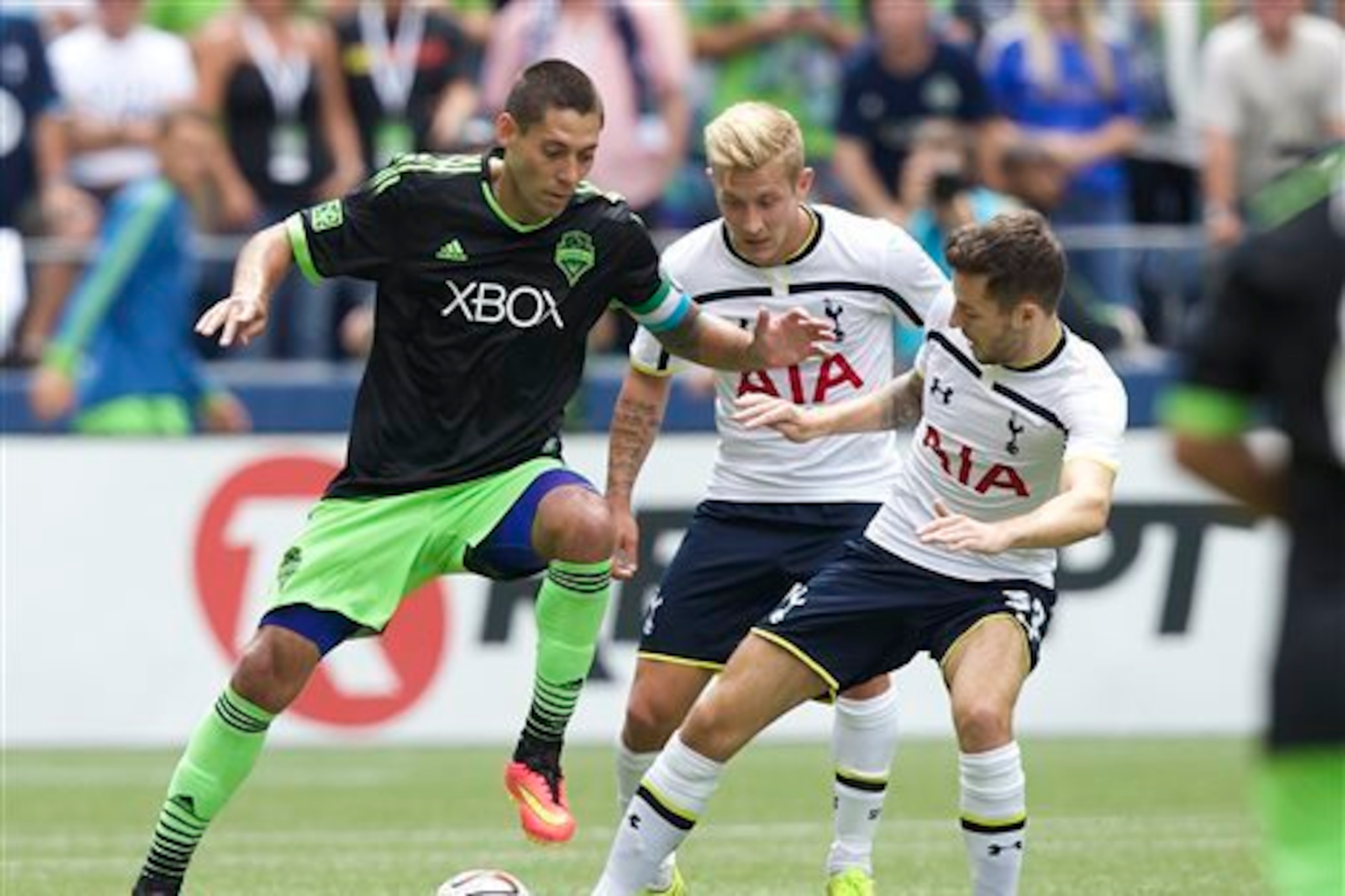 Ryan Mason attempts to tackle former Spurs-teammate Clint Dempsey. The midfielder held his own against Seattle without especially standing out.