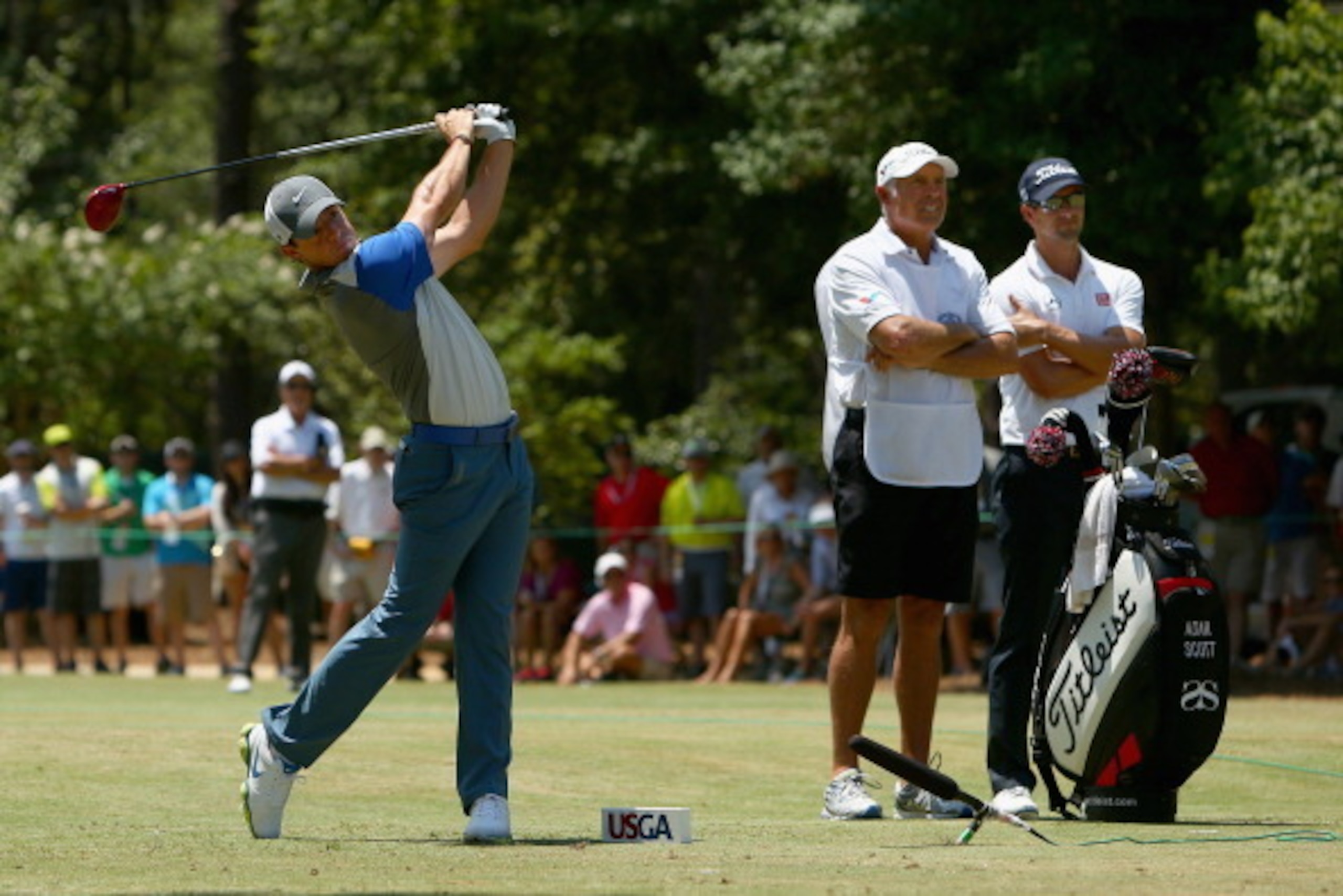 PINEHURST, NC - JUNE 15:  Rory McIlroy of Northern Ireland watches his tee shot on the third hole as Adam Scott of Australia looks on during the final round of the 114th U.S. Open at Pinehurst Resort & Country Club, Course No. 2 on June 15, 2014 in Pinehu