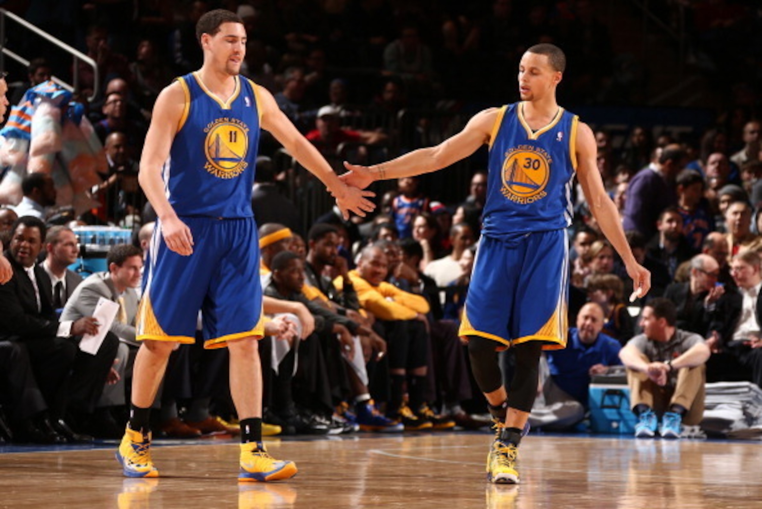 NEW YORK, NY - FEBRUARY 28: Klay Thompson #11 of the Golden State Warriors high-fives teammate Stephen Curry #30 during a game against the New York Knicks at Madison Square Garden in New York City on February 28, 2014.  NOTE TO USER: User expressly acknow